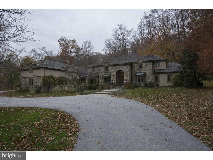 Positioned on a private street and off a long drive in the heart of Radnor township, find this elegant European styled estate home tucked on 6.5 open, wooded and conserved acres offering unparalleded solitude within a premium neighborhood setting  The classic exterior is complimented by a  modern floor plan with sweeping staircase, a two story foyer, and step down volume ceiling living room with fireplace and two sets of French doors which lead to the deep full length rear terrace and hot tub.  The formal dining room with gleaming hardwood floors, intricate crown moldings and bay window enjoys an eastern exposure, while the breakfast room/solarium provides a beautiful retreat space for informal dining or as an additional home office. All white gourmet  kitchen with generous cabinet space, granite counters, center island, gas cook top, stainless steel appliances and double wall ovens connects seamlessly to the vaulted family room with natural stone surround fireplace. Stunning Master suite with marble bath and generous closets is highlighted with a wood-burning fireplace and exit to the front of the house.  Adjacent to the master is another bedroom, ideal as a nursery or as expanded master space.  A library, with custom built-ins and paneled cherry wainscoting could also be purposed as an additional first level bedroom as it opens to a full bath.  Ascend the front stair to find four family bedrooms and  two full baths. Finished lower level offers wine cellar, recreation room with wood burning fireplace and outside entrance. A bonus room, accessed by independent stair case and located over the mudroom/family entrance provides large private office area or "bunk room"  A beautifully executed and presented house in a truly idyllic setting
