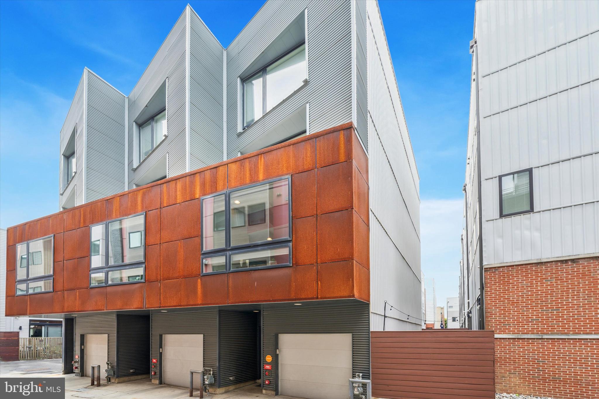 Fabulous Northern Liberties Galloway St. Gem. Discover this meticulously designed Callahan Ward 3 bedroom, 3 bathroom home boasting 2544 square feet of versatile living space and on a super quiet street. From the one car GARAGE to the ROOF TOP DECK with panoramic views of the city, this home is crafted for both comfort and style. Enter into the foyer with access to a full bathroom, the garage and a mudroom/flex room that leads to the lovely private patio perfect for outdoor entertaining. Head up to the next level which features an open concept living space large enough to host all of your family and friends. The kitchen captivates with granite counters and an oversized waterfall center island with bar seating, marble backsplash, a huge range for chefs of all skill levels, stainless appliances, pendant lighting and contrasting cabinet space offering ample kitchen storage. Flow through to the Dining room and living room complemented by the gas fireplace and a front window which almost takes up the entire front wall and that allows tons of natural light. Upstairs you will find the primary suite with a gorgeous bedroom, amazing walk in closet and a luxurious spa like bathroom with a spacious dual vanity, rainfall shower with bench seating and pebbled floor, linen closet and sparkling soaking tub. Continue up to the next floor and you will find 2 generously sized bedrooms, both with abundant light, a hall bathroom and a laundry room. This floor provides access to the stairs up to the roof deck which offers truly amazing city views and has a remote control retractable awning so that you can enjoy this space even on the hottest, sunniest days. In addition, the lower level is finished and offers space for an office, media, or play room and a storage room. One year remaining on Tax Abatement. This home is close to everything that Northern Liberties has to offer. With it's thoughtful layout and stylish updates, this beautiful home is ready for you to call it your next home. Schedule a showing today and experience the best of Philadelphia living at 614 N Galloway!