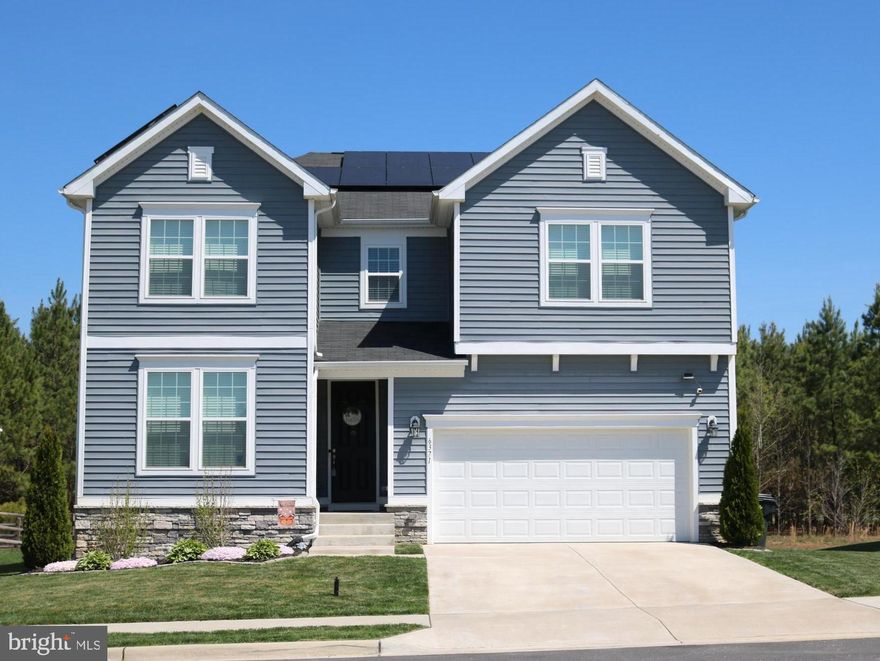 Fantastic well-maintained home in Hopyard Farm offering affordability without sacrificing quality! Convenient to Dahlgren Naval Base, this home features an incredibly spacious floor plan (the largest currently on the market in Hopyard!) with over 3500 finished square feet, 9-foot ceilings and 8-foot doors on the main level, 9-foot ceilings in the finished basement, a private office space, seamless flow from family room to kitchen which boasts a huge walk-in pantry with wood shelving, granite countertops, and stainless appliances, great primary bedroom with a very large walk-in closet, 4 additional spacious bedrooms (2 of which also have walk-in closets!), 3.5 bathrooms (all with quartz countertops and ceramic tile), and a convenient upper-level extra-large laundry room with plenty of space for folding table, storage, or other extras! The layout is designed for both relaxation and entertaining. Step outside onto your beautiful maintenance-free deck overlooking a wonderful level fenced-in yard that backs to trees and a walking path, perfect for morning coffee or evening gatherings. Govee permanent lighting and solar panels included with sale! Don't let this one slip away!