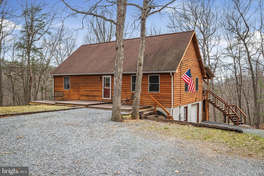 Welcome home  to this beautiful 3 bedroom, 3 bath home on 5 acres in Clarke County, Virginia!  From the exterior siding, which the current owners had stripped and stained, to the rebuilt, covered rear deck and updated back door, you'll see many improvements made by the current owners.  This home has a fabulous front yard that includes a firepit area with beautiful views.  There are two full suites with private bathrooms.  The 3rd bedroom has a walk in closet with recent upgrades of built ins in the closet, and built in shelves in the room.  Attic stairs and attic insulation were installed, as well as an attic fan.  New Luxury Vinyl Plank Flooring has just been added to the kitchen, foyer & two bathrooms on the main level.  The sellers have remodeled the lower level to include ceramic tile flooring in the family room, bedroom and full bath.  The remodel included a rear paver patio off the lower level bedroom, and a new downstairs, exterior door. In 10/2020, a new pressure tank and water heater were installed.  HVAC ducts were professionally cleaned at the end of 2020.  The Exterior grading has been redone to improve drainage away from the house, and new driveway gravel. Check out the large carport the sellers installed!  New well pump was installed in 2021.  A whole house water filtration system was installed in 2022.  Enjoy the 1 car garage with a ton of extra space for storage, hobbies, workshop, etc.  Behind the garage, and under the deck, there's a nice storage area which has a nice door that can be secured open (check out the ground level custom doorstop)  for access to entertaining on the rear patio.  You can even work from home (There is a bracket on the back deck used for a Winchester Wireless dish. The dish can be aligned to directly point to the cell tower.  Sellers had no issues with connectivity with two full-time teleworkers and often-overlapping Teams or Zoom calls.)