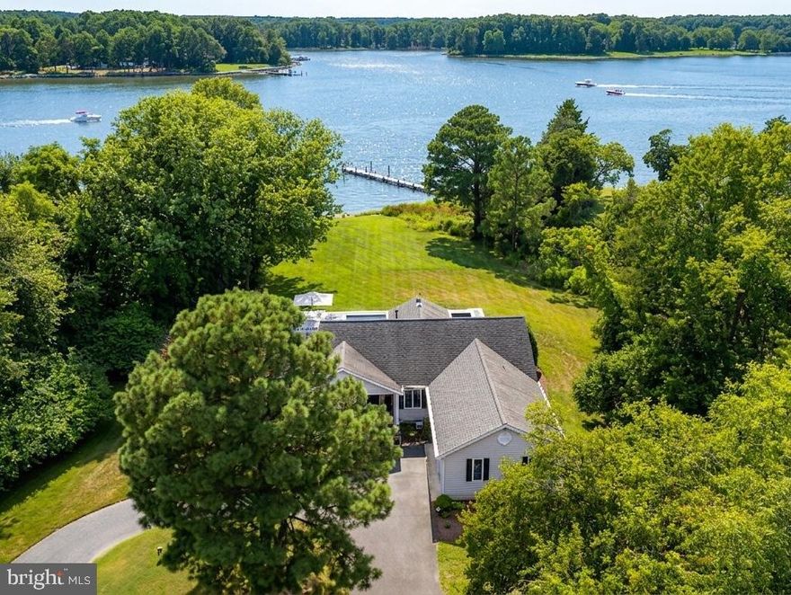 Nestled on 2.3 private acres in the sought-after Martingham neighborhood, this beautifully updated waterfront home offers one level living with the perfect blend of comfort, style, and outdoor living. Overlooking Porter Creek, the property features a private pier with lift and rip-rapped shoreline, where you can enjoy breathtaking sunsets, and endless days enjoying the water. Inside, the open floor plan flows effortlessly from the spacious living areas, open dining area, to the fully renovated kitchen, complete with quartz countertops, custom cabinetry, and modern appliances. The expansive waterside owner’s suite has a luxurious bathroom with heated tile floors, and generous closet space. Two additional bedrooms, plus a den that could serve as a fourth bedroom and custom bathroom. Step outside to a screened porch with awning or lounge beside the tiled gunite heated saltwater pool, Pebblesheen finish and surrounded by a custom deck—perfect for entertaining or quiet relaxation. Additional highlights include a two-car garage with attic storage, a laundry room with utility sink, stacked washer/dryer, and a 4-ton Legacy heat pump for year-round comfort. This is a rare opportunity to own a meticulously maintained home in one of St. Michaels’ most desirable communities, where privacy, luxury, and a waterfront lifestyle come together beautifully. Experience life alongside one of Maryland’s finest golf courses - across the street of the award-winning Links at Perry Cabin Golf Course—a premier golf destination designed by the legendary Pete Dye.