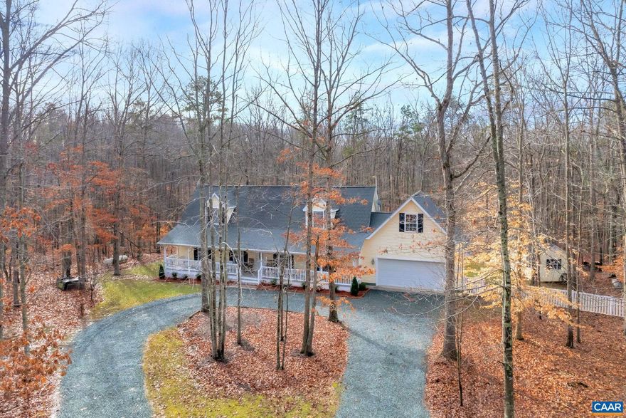 Are you looking for a peaceful property that is less than 15 minutes to Charlottesville? You will not want to miss this private estate. This home is just over 2800 sq feet tucked away in 13+ acres of gently rolling hardwoods. Come enjoy watching the wildlife from your full front porch. When entering you will notice the gorgeous custom tile in the foyer. On the main level there is an open design with a large dining room, kitchen, family room w/wood fireplace & breakfast nook. The kitchen has white cabinets, solid countertops, cabinet pantry, & a large island with seating. You will find a bedroom with a full bath plus the master bedroom & bathroom on this level.  There is a powder room for your guest & washer/dryer. Off the mud room you step into your oversize 22x24 two car garage. Upstairs there are 2 additional bedrooms with a full bathroom. Off the back of the home there is a large deck, shed w/electricity, & huge fenced in yard. Right outside of the fenced area are several wide well maintained trails around the property & even a small bridge off the creek. Don't worry about losing power at this home since it has a full house generator. Firefly internet is installed. Owners have maintained this home and are selling ASIS.,Solid Surface Counter,Wood Cabinets,Fireplace in Great Room