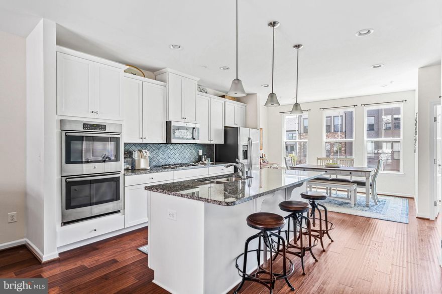 MOTIVATED SELLER DROPPED $40K NET FROM ORIGINAL LIST PRICE!!  SELLER TO PAY $12,000 TO APPLY TOWARDS BUY DOWN (DISCOUNT POINTS) OF BUYER'S INTEREST RATE!!!   Lovely 4 level townhome with rooftop terrace only 1/3 mile from Silver Line Metro!  Fantastic and easy access to the city while having the open space and relaxed feel of the suburbs!  Perfect work from home situation or commute to the city!  This spacious townhouse is 2840 square feet with 4 bedrooms, 3 full and 2 half baths, covered balcony, with 2 car garage plus driveway!  Entry level first floor is an open recreation room for an additional living space or work space, along with an arrival center and half bath.  Climb up the oak stairs to see the open concept main level with beautiful hardwood throughout.  Gourmet modern kitchen is in the center with white classic cabinets, beautiful granite counters and on large island, stainless steel appliances, along with double oven and cooktop.  On either side is the dining room and spacious great room leading to the covered balcony for enjoying the outdoors but with protection on hot or rainy days!  Third level has 3 bedrooms and 2 full baths including the primary bath with dual vanities and upgraded tiles.  The 4th and top level is an open loft for yet another living space for movie or game nights, along with a 4th bedroom and full bath.  Enjoy the sunrise or sunsets on your rooftop terrace on this top level!  There are wonderful amenities in sought after Westmoore -   the community pool, clubhouse, exercise room, 2 parks including Evermore Park with its dog parks, amphitheater, large open grass space, 2 tot lots/playgrounds, and miles of walking/jogging trails throughout the community.  Not to mention a fabulous location so close to the Silver Line Metro, very close to everyday conveniences (shops and stores), quick access to the Dulles Greenway, not far from One Loudoun, and less than 10 minutes from the Dulles International Airport!