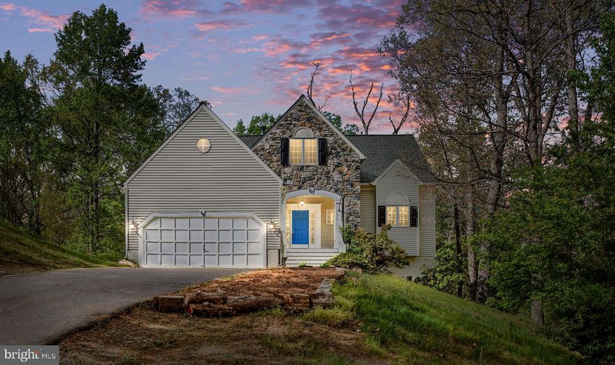 BEAUTIFULLY Maintained, 5BR, 3.5BA 3-Level home w/No HOA.  VA Assumable Loan.  Features Include Hardwood Floors Throughout Main Level,  Freshly Painted, Sunken Living Room w/Soaring Picture Windows, Quartz See Through Gas Fireplace; Family Room  Built In Book Shelves, Gas Fireplace w/Wood Mantel, Double Glass Doors That Lead Out To A Large Covered Deck Overlooking Aquia Creek.  Kitchen w/Granite Counters & White Cabinetry, Recessed Lighting, All New Stainless Steel Whirlpool Appliances.  Separate Dining Room w/Large Picturesque Windows and Wainscotting, Upper-Level Features an Owner's Suite w/New Carpet, Vaulted Ceiling, Fresh Paint, Ceiling Fan w/Light, & Wall Lined Windows;  Updated Ensuite Shower Door, Fresh Paint, Tile Flooring, Storage, 2 Vanities Each w/Mirrors, Skylight Over A Tile Lined Soaking Tub. 3 Additional Bedrooms w/Brand New Carpet, New Paint, Window Lined Flex Room For A Nursery, Exercise Room, or Den.  Hall Full Bath w/Tile Floors, Fresh Paint, Vanity w/Storage, & Tub/Shower.  Lower Level Features Access To A 2 Car Garage, Huge Laundry/ Utility Room with Conveying Washer and Dryer, Storage Space, and Utility Sink.  Continue Down The Stairs To A Fully Finished Basement w/ Carpet, Flex Room For A Bar, Storage Space Or Mud Room.  Recreation Room With Theater System (Speakers, Screen),  Wood Fireplace, 2 Additional Bedrooms, Full Bathroom w/Tile Flooring, and Rear Door That Leads Out To A Tree Lined Fully Fenced-In Backyard Overlooking Aquia Creek.  School Bus Stops At The Bottom Of The Driveway.  Home Is Less Than 1 Minute From The TBS Quantico Gate And Approximately 5 Miles From 2 HOV Lots.