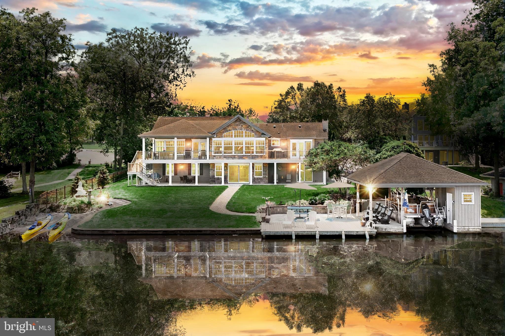 Luxury Lakefront Estate with Private Boathouse, Breathtaking Views & Unmatched Craftsmanship
This extraordinary five-bedroom, three-bathroom custom lakefront home is an exceptional opportunity for those seeking refined living and year-round recreation in a lake community. Thoughtfully designed with impeccable craftsmanship and stunning attention to detail, it blends elegance, comfort, and lifestyle all on one of Lake Meade’s most coveted waterfront lots. Step into the foyer and immediately sense the quality and care poured into every inch of this home. A wall of windows frames panoramic lake views in the great room, where soaring ceilings, a gas fireplace, and rich hardwood floors set a warm, sophisticated tone. Natural light floods the main level through strategically placed Sun-Tubes, creating an inviting, uplifting atmosphere. The open-concept kitchen is an entertainer’s dream. It features cityscape cabinetry, granite countertops, a custom center island with breakfast bar, an elegant backsplash, and abundant storage, including a furniture-style triple pantry with pullout shelving. Every cabinet is beautifully finished inside and out.The spacious dining area connects seamlessly to a covered, composite deck with vaulted ceiling, aluminum railings, ceiling fan, and serene lake views—perfect for morning coffee, casual gatherings, or relaxing in the shade. For sun lovers, the open sun deck offers another venue to unwind.The main-level primary suite is a peaceful sanctuary with a tray ceiling, recessed lighting, private deck access, and a second fireplace. The en-suite bathroom rivals a luxury , a walk-in tiled shower with stone flooring and a bench, dual vanities, and generous storage. A massive walk-in closet completes this serene retreat.Another well-appointed bedroom with crown molding, full bath, and a large, bright laundry room with built-in cabinetry and utility sink complete the main level.Lower-Level Luxury & VersatilityThe finished walk-out lower level offers equally impressive lake views and versatility for entertaining or extended family living. It includes a full kitchenette with sink, fridge, microwave, breakfast noo, spacious family room with fireplace, game room, and access to a second covered patio.Three additional bedrooms—one with a walk-in closet and lake views—plus a full bath make this space ideal for guests, multigenerational living, or an in-law suite. Whether coming in from the water or hosting weekend visitors, this level adapts beautifully to your needs
Exceptional Outdoor Living & Lakefront Features
Private, covered boathouse with changing room, mini-fridge, and storage Beautiful stone walkway leading to the lake Kayak launch and swim area Composite decking and aluminum fencing for easy maintenance
Meticulously hardscaped and landscaped yard designed for both beauty and function Oversized three-car garage with high ceilings and an ample walk-up attic space perfect for storage, an art studio, or future finished space.
Lake Meade is a private, gated community spanning 300 acres of shimmering water with nearly 5 miles of shoreline. Residents enjoy: Boating, kayaking, paddleboarding, tubing, wakeboarding and sailing—with speed and safety regulations for peaceful enjoyment.Excellent fishing with bass, crappie, perch, walleye, and more
Lifeguarded pool complex with waterslide, zero-entry play area, and diving boards
Sports facilities include basketball, tennis, pickleball, volleyball, soccer, and baseball
A welcoming clubhouse and neighborhood eatery
Year-round community events, including the annual Fourth of July fireworks celebration
Onsite Northeast Adams Fire & EMS station, and public water/sewer for peace of mind
Every inch of this property was thoughtfully planned and built for those who value quality, comfort, and community. From sunlit mornings in the kitchen to incredible views and unforgettable sunset cruises from your private dock, this home is more than a place to; it's a lifestyle.
