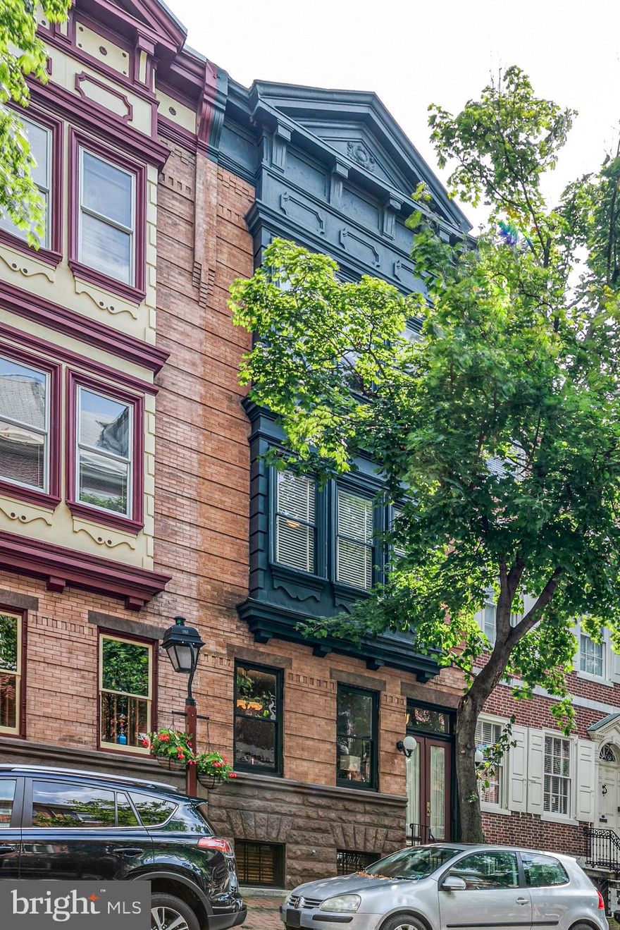 Be prepared to be wowed the moment you walk into the foyer. This grand, Federal period home is everything a Society Hill home should be; high ceilings, crown molding, 2 wood burning fireplaces, three zoned heating and cooling system and 2 CAR PARKING! This sprawling 4 bedroom, 3.5 bath home goes street to street (to Addison St) (17.5 x 135) and is everything you've been looking for. Numerous and extensive renovations throughout. Enjoy the open living room and dining room separated by a meticulous wood burning fireplace. Or, invite everyone into the large kitchen complete with a large, comfy family room with double doors that lead to a beautiful, private garden with a brick walkway to the 2 Car parking. Amazing wet bar sink, cabinets and storage in both the garden patio and roof deck. The 2nd floor features a main bedroom suite, with a true walk-in closet. There is a washer and dryer on this level. Need to get some work done? This light filled office is complete with double storm doors and a Juliet balcony that can quickly lead to the back garden just down the spiral staircase. The 3rd floor offers 3 additional bedrooms and 2 full bathrooms. The sky's the limit as you head up to the fabulous roof deck for fireworks, a nice sunset or just to enjoy the amazing city views. Need more space? The massive, clean basement has another washer/dryer and high ceilings ready for you to finish, complete with an exit door to the garden or parking. This is the one that you've been waiting for!