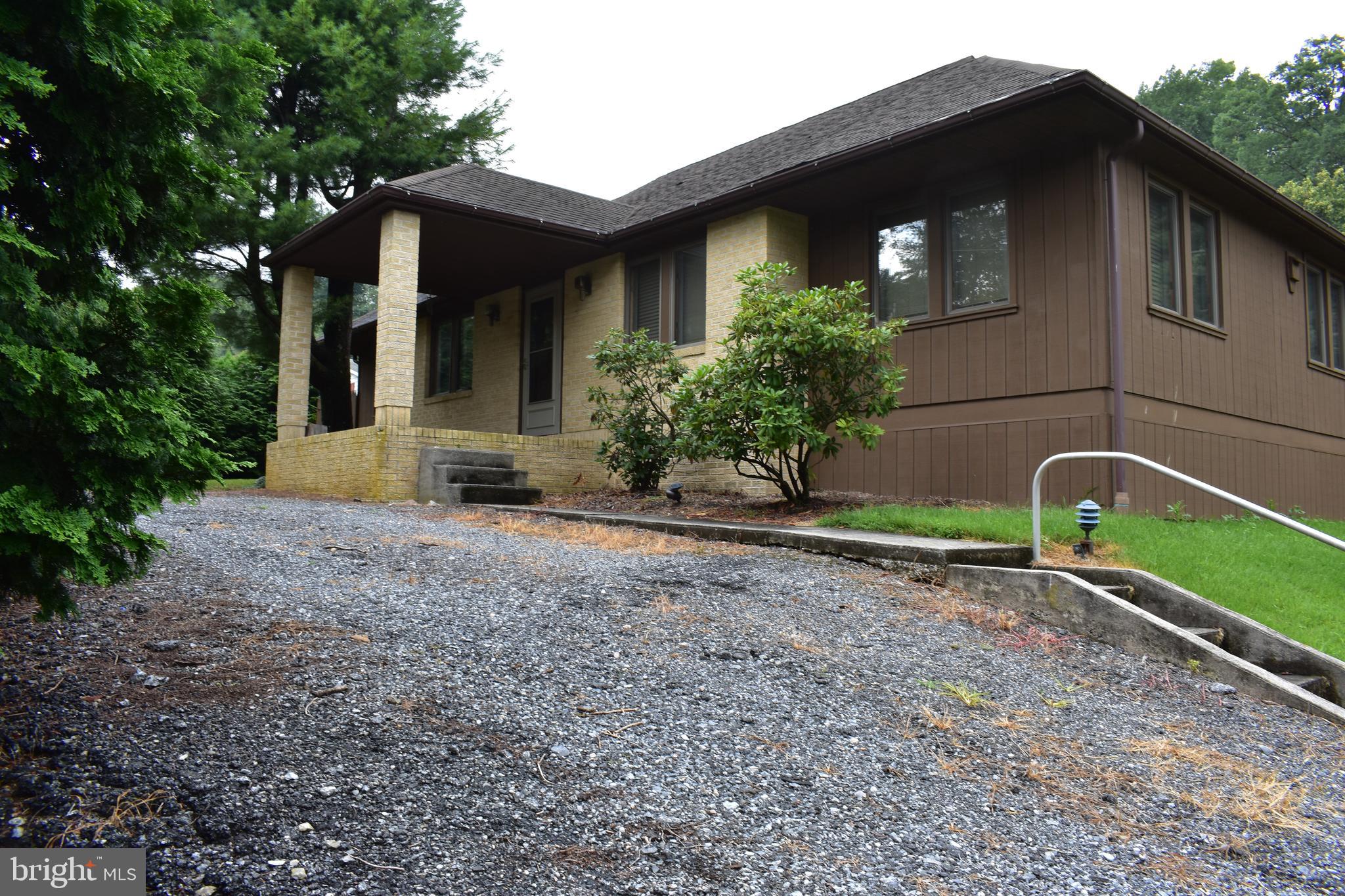 Seeing is appreciating this unique home on almost 1/2 acre. 2 private beds upper level. Large master with walk-in closet & bath on 1st floor. Beautiful dining room with fireplace and wood vaulted ceilings. Large detached cement floor covered pavilion with fireplace. Detached oversized 1-car garage. Needs some cosmetics but is livable while you remodel.