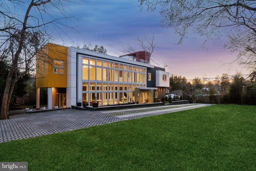 Perfectly sited atop a hill, this exceptional custom contemporary home boasts an expansive rooftop terrace that fully embraces the breathtaking views of its lush, surrounding landscapes. The lot is adorned with mature trees, ensuring both seclusion and privacy. The striking front elevation features a massive wall of windows, setting this residence apart, and providing immediate curb appeal. Inside, the sleek and light-filled interior showcases an open-concept floor plan, soaring ceilings, and a floating staircase, creating ideal spaces for both intimate gatherings and large-scale entertaining. Constructed with commercial-grade techniques and materials such as steel and glass, this home offers enhanced structural integrity with minimal maintenance. An added bonus is the attached full in-law suite on the lower level, which is private and has its own access, allowing for versatile usage.

$250,000 PRICE REDUCTION IN THE LAST 2 WEEKS. MOTIVATED SELLER—BRING ALL OFFERS!