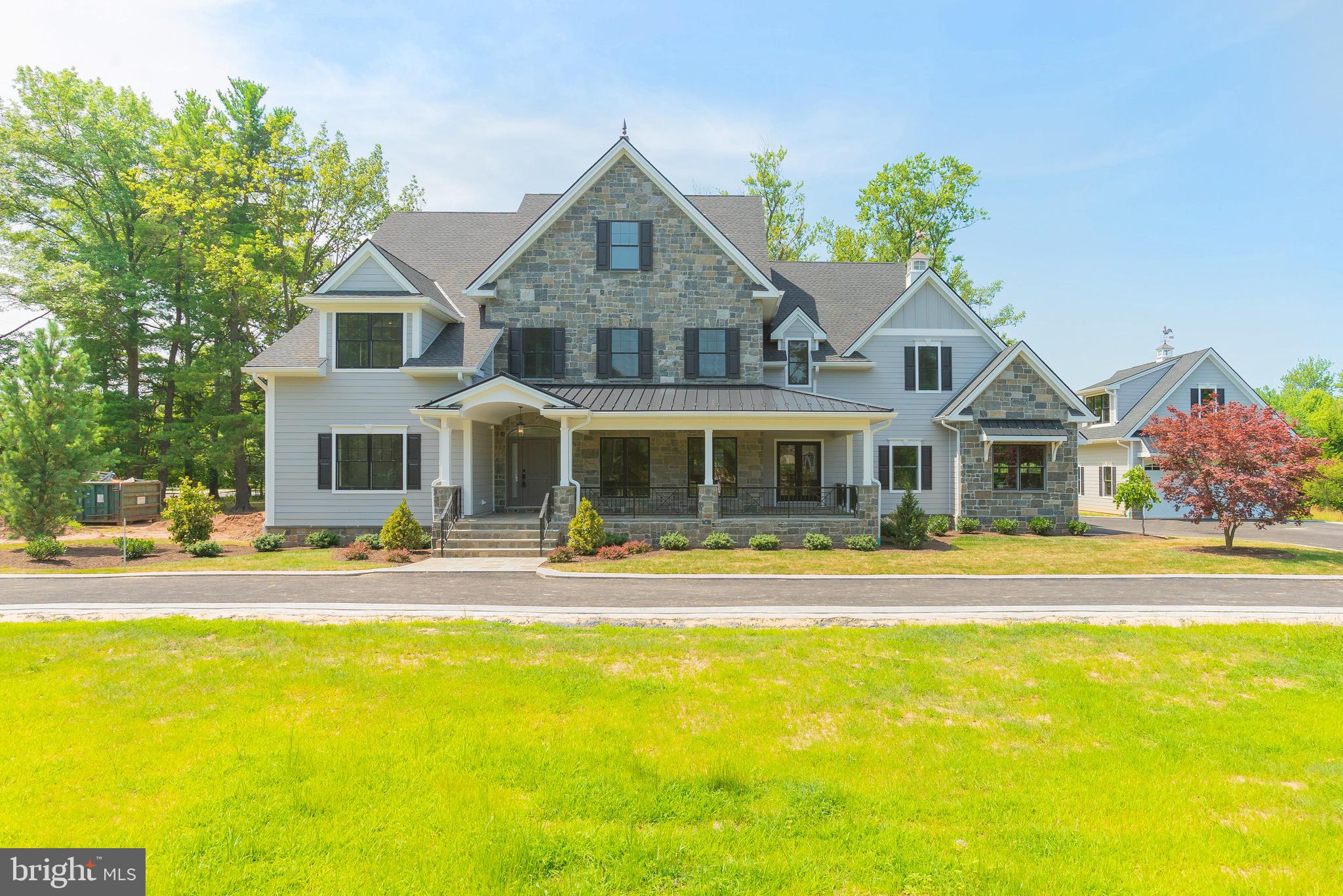 Unlike anything you've seen, the home of your dreams has been brought to life at 1309 Cedar Hill Rd. Set on a gorgeous corner acre lot of land, this palatial 7,400 sqft, 7 bed, 6.5 bath estate has everything you want, need and wish for, plus so much more! Each entrance is flanked with stunning pillars with imported stone - the drive aisles guide you past the lush, landscaped front yard to the main home's 3-car garage and auxiliary 2-car garage and loft, which can be converted into another apartment. At the front entrance, an expansive natural stone, wrap-around porch overlooks the manicured garden space. Inside the home, you're greeted by a large foyer that opens to the bright formal dining room with tray ceiling, recessed lighting, and hardwood floors that run throughout. A guest suite is conveniently placed on the other side of the foyer - this space can also be used as a large office or kid's play room. The heart of this home is the show stopping Chef's kitchen. Every inch of this bespoke kitchen has been handcrafted, from the custom white and gray shaker style cabinets to the Quartz countertops that carry through the backsplash, and a designer cabinet paneled and stainless steel appliance package. The kitchen includes an incredible wine fridge and Espresso/coffee machine built into the cabinetry. An oversized island with seating for 6+ makes this the perfect place for the whole family to gather. The kitchen opens to a separate breakfast room surrounded by windows and a massive light-filled family room adorned with coffered ceilings and a gas fireplace. The beautiful, elegant living space transitions to the exterior where you will find a stunning covered flagstone patio and a large flat yard, the space has been designed, and plumbed for a full outdoor kitchen. Off the kitchen is a powder room and mudroom with custom millwork cabinets, storage and coat hooks. The 3-car garage with a beautiful polyurethane floor coating can be accessed here as well. A secluded office with a private exterior entrance completes this level. On the finished lower level you ll find an expansive media room with plenty of open space to arrange a layout that best fits your entertaining needs. There's also a full bathroom, additional bedroom and another finished space that could be a large wine cellar or workout room. On the second floor, hardwood floors run throughout the 4 spacious guest bedrooms. Two of the bedrooms offer private ensuites and the other two share a stunning Jack-and-Jill full bathroom. A huge laundry room, with custom cabinetry and sink, is conveniently located off the hall. Finishing this level is a luxurious owner's suite comprised of a large bedroom with bright windows, a gas fireplace and a full custom walk-in closet. The spa-like ensuite provides a daily retreat with it's free standing soaking tub, rainfall shower head, and double vanity. The final level of this spectacular home is an unfinished attic that offers flexible space for storage or future customization. This fantastic Lower Gwynedd location is only minutes from Whole Foods, Trader Joes, Wegmans, and GIANT. RT202, RT309, and the Lansdale/Doylestown Line are also close by for easy access to Center City Philadelphia, King of Prussia, and other surrounding neighborhoods. Contact us today for in-person and virtual touring options! Make your dreams a reality at 1309 Cedar Hill Rd!! *All square footage numbers are approximate and include above and below grade square footage. Square footage & real estate taxes should be verified by the buyer.*