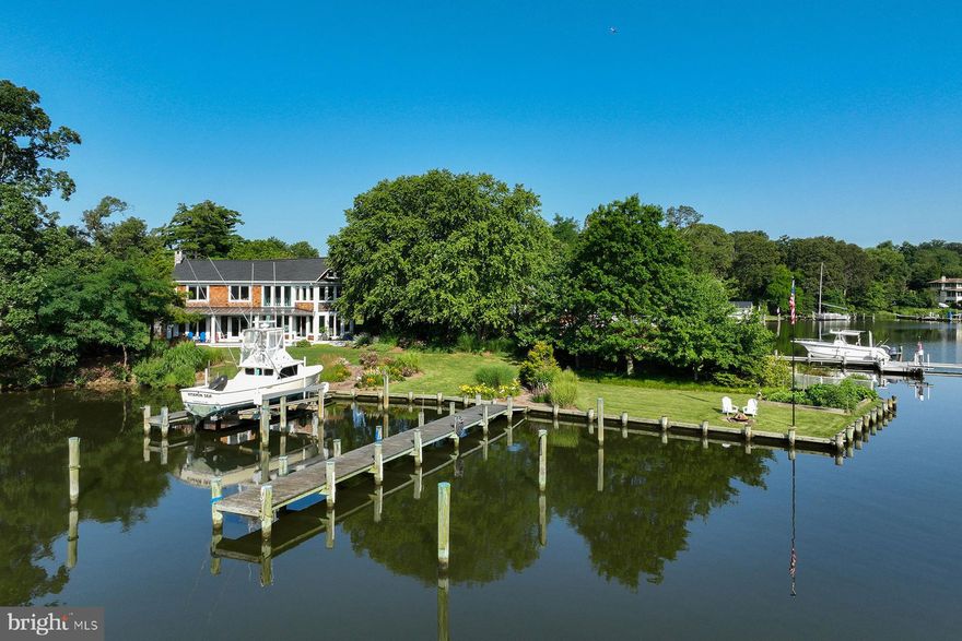 Welcome to 3307 Harness Creek Road-- a Nantucket style, coastal home with spectacular water views, a private backyard oasis and two deep-water piers on protected Harness Creek. This waterside gem, with 190 ft of waterfrontage, is situated directly across from Quiet Waters Park and offers quick access to the South River and the Chesapeake Bay.
Inside, you’re greeted by the natural warmth pouring in from the numerous floor-to-ceiling windows on the main level. The foyer starts a seamless transition to the living room on one side and the kitchen on the other. A central island draped by granite countertops centers the kitchen. Casual and formal dining options make the home great for entertaining. Adjacent to the kitchen is a walk-in pantry with quartz counters, sink and additional storage. The washer and dryer are also conveniently located here. 
A cozy sitting area surrounded by bay windows shifts into the main living area. This space features many special details: a wood-burning fireplace, a window seat, and immediate access to the waterside ipe decks. Gorgeous hardwood floors are throughout the house. Closets and a powder room complete the main floor layout.
As you approach the staircase to go upstairs, you’ll notice the beautiful ribbon striped Sapele treads and one-of-a-kind detailing in the railing construction that add another creative touch to this special home. The two-story sitting area brings the natural light into the stairwell. The primary suite includes a spacious bedroom with fabulous Harness Creek and Quiet Waters Park views. The ensuite bathroom has a double-bowl vanity, soaking tub, and oversized shower with glass tile accent. There are two additional water view bedrooms upstairs and an updated hall bath. 
On a coveted street close to downtown and providing easy access to Routes 97 and 50, a short walk to the local winery, or a paddle to hiking trails in Quiet Waters Park, this home’s prime location and modern interior make it the perfect combination of boater’s heaven and entertainer’s dream. 
One of the best features of this property is the privacy in the lush, waterside yard. Adjacent to the main level living room, there is a spacious ipe wood deck with standing seam metal roof. Relax here and watch the paddlers on Harness Creek and the parade of boats and wildlife. With beautiful landscaping and hardscape, the sumptuous yard adds to the serenity of the waterfront scenery. The two private piers complete with water and electric offer tons of options for the serious boater. One pier is 46 ft and includes a 20,000 lb boat lift, 30/50 amp. electric, fresh water supply and has 5+ ft water depth. The second pier, with fresh water supply, is 76 ft long and can accommodate a sizable sailboat; here, the water is 8 ft at mean low tide. The outdoor spaces and interior detailing work in tandem to create a polished encapsulation of coastal living in Annapolis.
Major system updates include: new two zone high-efficiency 21 SEER Bosch HVAC systems (2024, 2023), treated water for irrigation, sprayed foam insulation in crawl space, new refrigerator, Dacor dual fuel range with propane cooktop, exterior landscape lighting, alarm system, freshly painted interior, new window treatments, and a new roof in 2022.