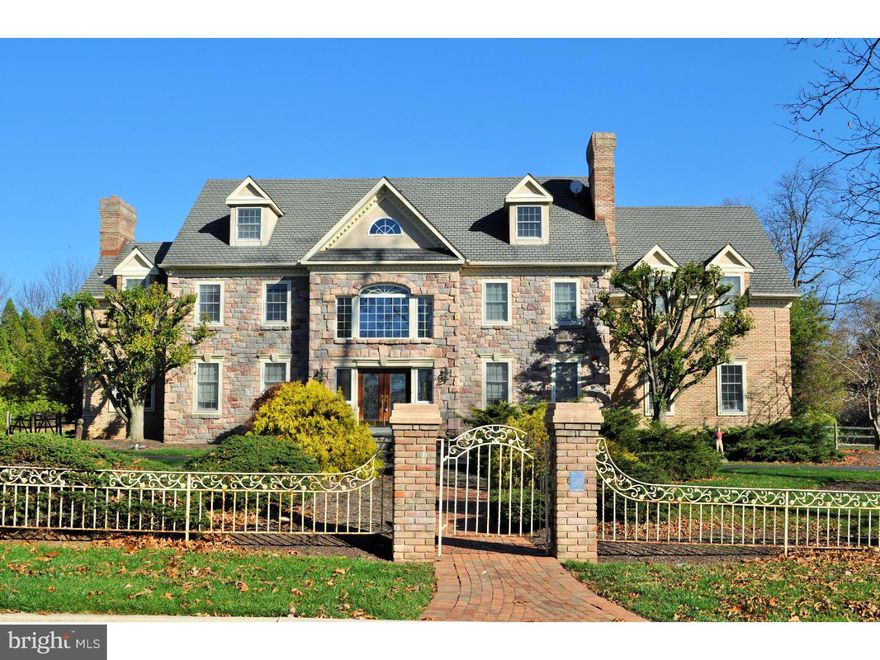 This magnificent home reveals beautiful architectural details, natural light and a breathtaking  setting on over 2 lovely acres. Enter into the grand foyer with vaulted ceilings, marble floors, and an elegant curved staircase. The formal living room offers plenty of entertaining space and opens into a library that includes a fireplace for curling up with your favorite book. The central focus great room displays a beautiful brick fireplace, vaulted ceilings, an entertaining bar and a sunroom great for your morning cup of coffee while gazing out of the large windows. The home showcases an open floor plan around the kitchen and family room for gatherings, and formal office with walk out to one of the patios, convenient access to 2-car garage and spacious finished basement with ample storage. Office may easily be converted into a 3rd car garage bay. The kitchen with breakfast nook hosts plenty of cabinets and counter space, enticing the most discerning cook, and is ready to offer culinary feasts to be enjoyed in the formal dining room. The 2nd floor offers 4 generous bedrooms, including the master suite with vaulted ceilings, abundant light, fitted walk-in closet and spa-like bath with marble sunken whirlpool tub and shower.  A convenient laundry room makes for comfortable access. On the 3rd floor are two additional rooms for many options to enjoy the luxurious ambiance. Opportunities await as you move outside into the expansive yard. A perfect place to play football while waiting for the Thanksgiving turkey, host the company barbecue, or even welcome other families for a lively pool party. Home located in sought-after Wissahickon School District.