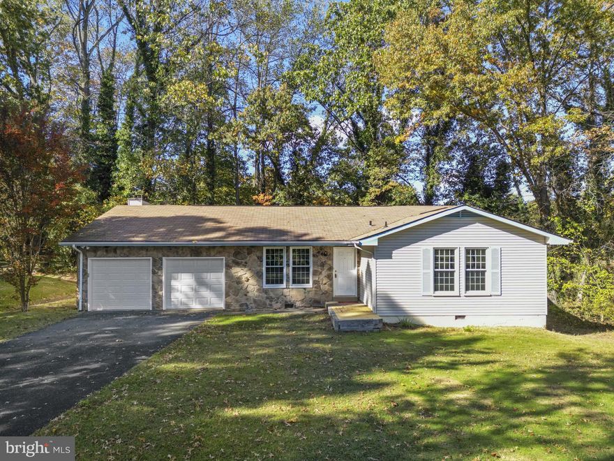 UNDER 500$ IN AQUIA HARBOUR one level living and you're on the Golf Course! Fairway 5 circling around your backyard, and the 6th tee view from the front door. Three Bedroom, 2 Full Bath 2 car garage, updated Rambler sitting on a beautiful flat/level 'Golf Course' lot which you view from all angles of the home. Newer Grey high pile carpeting in all 3 Bedrooms and Living room. Newer Grey Luxury Vinyl Plank Flooring in the Hallways, Dining Room, and the Huge Family Room with a beautiful stone hearth woodburning fireplace.  A warm soft grey wall paint, accented with a gloss white trim greets you. Newer washer and dryer. Newer double hung windows installed 2-8-2023, by Window World! Views of Aquia Harbour's Golf Course from the front tee in the front of the home to the fairway in the back and side views from the home in this nice big Rambler, 1770 square feet. Aquia Harbour offers our new buyer an array of amenities i.e., Boat Marina on Aquia Creek offering access to the Potomac river, 2 Pools, 2 Restaurants, Ball fields, Basketball and Tennis Courts, Parks, Walking Trails, Horse stables, in the community of Aquia Harbour!! Asphalt drive redone 2015. Newer Kitchen Stainless Steel Appliances, with Newer Cabinetry, and Counters, too!! Come see this great opportunity to live on the Course! The Price is Right!