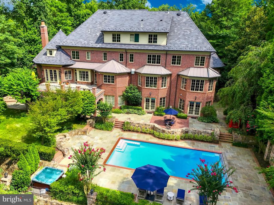 Over $700,000 price reduction—don't miss this exceptional opportunity! The Reserve stands as McLean’s most coveted residential community, featuring approximately 170 luxurious custom homes set among rolling hills, all within an exclusive guard-gated enclave. Within this distinguished enclave, set in an idyllic setting 852 Alvermar Ridge stands proudly with over 13,000 square feet of exquisite living space. The property showcases a stately paver motor court and a stacked stone facade, enhancing its impressive curb appeal. Upon entering, you are welcomed by a majestic mahogany staircase in the foyer, illustrating the home’s luxurious craftsmanship and attention to detail. The floor plan masterfully balances formal and informal living spaces, maintaining symmetry and proportion throughout. The gentleman’s library is elegantly appointed with mahogany and detailed coffered ceilings, offering a sophisticated and quiet space for reading or study. The large formal dining room is ideal for grand banquets and is seamlessly integrated into the flow of the house, ensuring a stately yet welcoming environment.

Central to the home, the kitchen features elegant cabinetry, superior stonework, and is complemented by state-of-the-art appliances. Adjacent is a bright breakfast area, providing a delightful space for morning meals and casual dining. The family room, accessible from the kitchen, offers access to the outdoor balcony, perfect for indoor/outdoor living and entertaining.

The primary suite, located in a private wing on the upper level boasts a serene sitting area, a sumptuous sleep area with picturesque views, and luxurious spa-like bathrooms with freshly renovated Calcutta marble and walk-in closets. 

The lower level is designed for entertaining, featuring a sophisticated lounge with pool access, a professionally equipped wet bar, and a climate-controlled wine cellar with a 1,500-bottle capacity. The expansive grounds are perfect for hosting, featuring a stone terrace with an impressive pool, hot tub, and meticulous landscaping. Additional luxurious amenities include a robust Cummins generator, a newly renovated $125K back deck, elegant lantern heads on the driveway columns, and a mahogany elevator servicing all four levels, all designed by Custom Design Concepts. Freshly painted interiors enhance the rich mahogany woodwork that graces each level.

The Reserve, McLean’s most exclusive residential enclave, offers unparalleled security with 24-hour patrolling and a suite of bespoke concierge services at the elegant gatehouse. Situated just minutes from Tysons Corner and the Beltway, this grand estate offers unparalleled luxury, security, and the distinguished prestige of McLean’s finest residences.