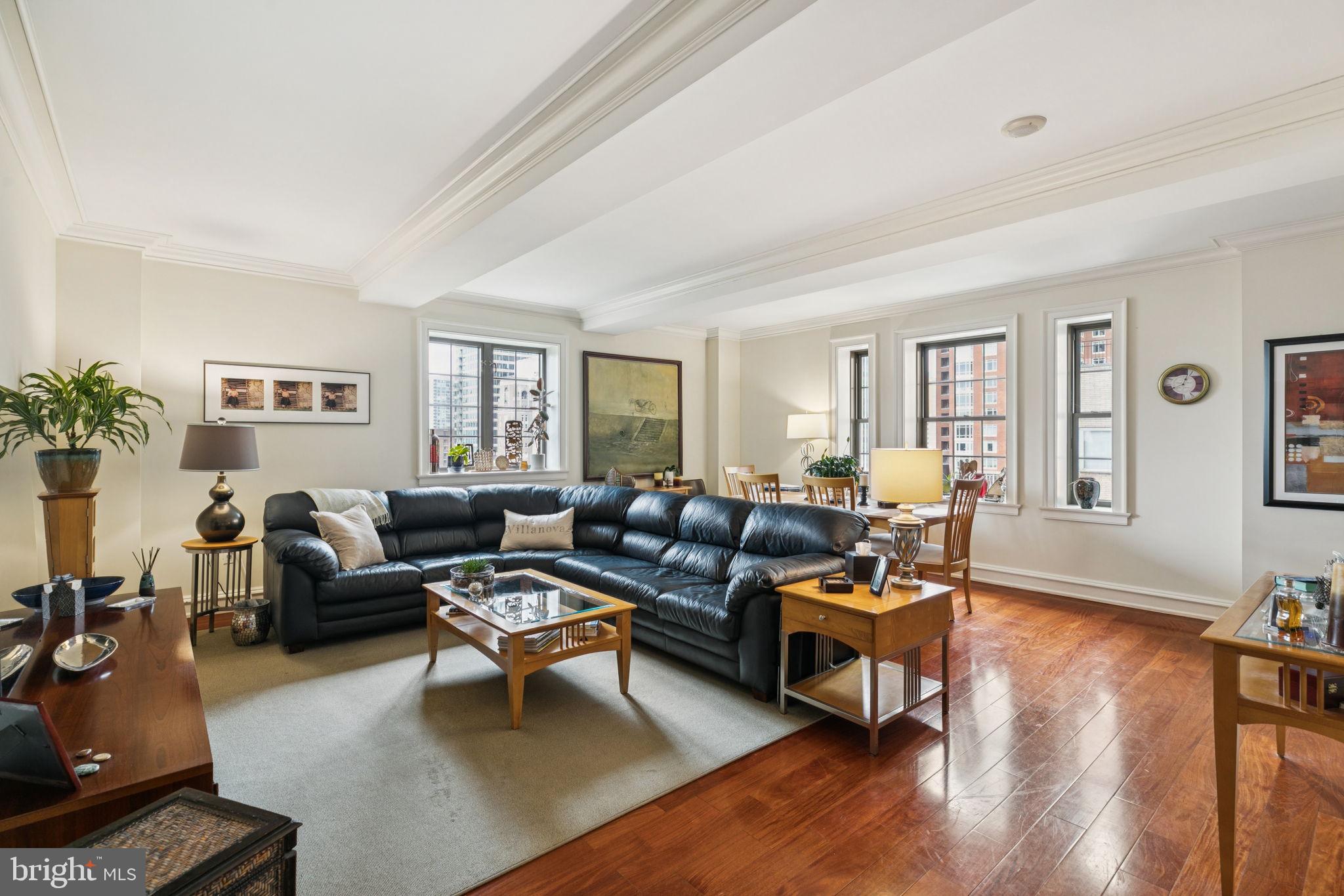 Beautifully appointed corner two bedroom with all rooms looking out onto Rittenhouse Square at Parc Rittenhouse. Enjoy some of the best views in the city at this luxurious two bedroom, two bathroom residence with a premiere Center City location and excellent floorplan. Enter through a grand foyer with large coat closet into the spacious, open great room boasting oversized windows with sunset views over Rittenhouse Square, architectural ceiling details, and ample space for living, dining, and entertaining. Open to the dining area is the high-end kitchen with flat panel dark wood cabinetry, granite countertops, marble tile floor, and stainless steel appliances including a Sub Zero fridge. On the other end of the residence is the expansive primary suite with another window overlooking The Square, two walk-in closets with custom built-ins, and an ensuite marble-appointed bathroom with a double vanity, built-in storage, and large glass-enclosed walk-in shower. There is an generously sized second bedroom with large wall closet that enjoys use of an adjacent full hall bathroom with white vanity, tub shower, designer marble tilework, and a laundry closet with stacked ASKO washer/dryer. Additional home highlights include beautiful moldings and trim, recessed lighting, and hardwood floors throughout. Residents of Parc Rittenhouse enjoy world class amenities and services including a 24 hour doorman; an amenities suite that includes a brand new state-of-the-art fitness center and resident lounge with pantry; media room; outdoor rooftop pool club with a large pool deck, full size pool, kids pool and hot tub; garage parking below the building for an additional fee; and two amazing restaurants on the ground floor, Stephen Starr’s Parc and Via Locusta.