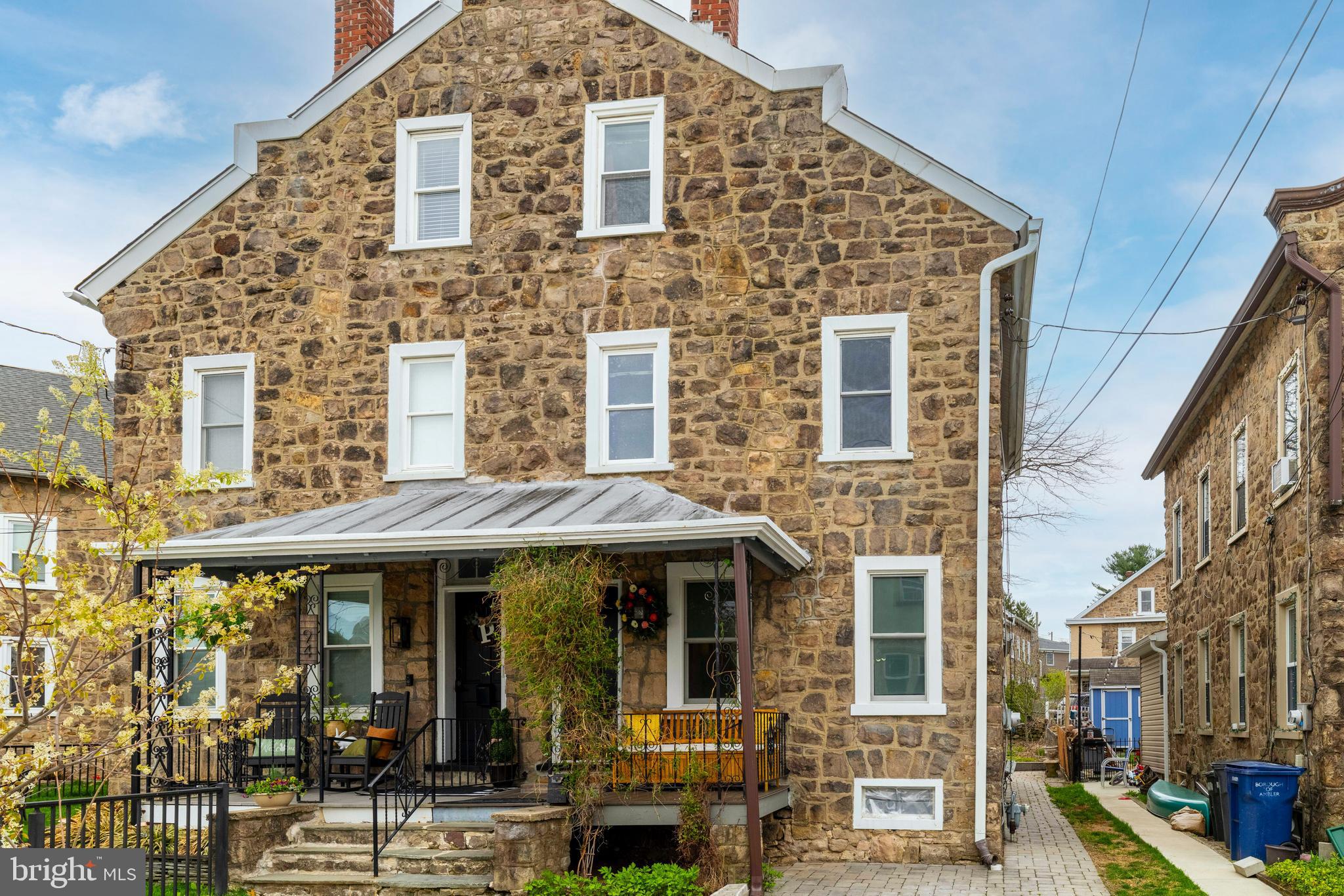 Welcome to 92 Orange Avenue, a classic three-story stone twin, brimming with charm in the heart of Ambler Borough and the highly rated Wissahickon School District. This 19th Century home, crafted by Italian stone masons, offers beautiful original details including rich hardwood floors, high ceilings, and timeless millwork, all adding to its warm and character-filled appeal. Convenient one car off-street parking and an inviting front porch welcomes you. Inside, you'll find living and dining rooms with deep windowsills throughout and high ceilings, displaying fine craftsmanship and historic materials. The bright, modern kitchen features tiled flooring, a new gas stove, a dishwasher, eat-in space, and doors to the basement, back porch, and yard. Out back, a private yard with upgraded paver patio and built-in drainage system creates an ideal setting for outdoor dining and entertaining, with native perennials and vines creating a summer oasis. Upstairs find four bedrooms, offering spaces for a multitude of purposes. The second floor offers three bedrooms, full linen closet, and a cheery hall bath. The third floor comprises two large rooms available for additional flexibility. The home is located just two blocks from all that downtown Ambler has to offer, including a variety of shops and restaurants, cafes, parks and playgrounds, as well as local favorites such as Forest & Main Brewery, Sweet Briar Ice Cream, the historic Ambler Theater, Churches and the Act II Playhouse. The train station offers a convenient, 25 minute commute to Center City, as well as safe, easy access to the Wissahickon Trail, area green spaces, and bus stops for the highly rated Wissahickon School District. A wonderful opportunity to own a home full of character and charm, right in the heart of one of Montgomery County’s most desirable communities.