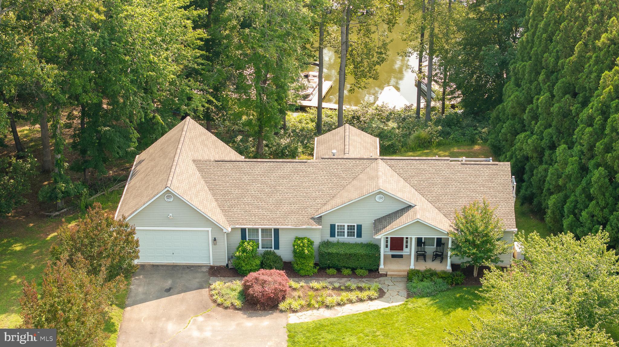 Welcome to your dream park waterfront home in the coveted Wyndemere community on the public side of Lake Anna. Enjoy all the perks of lakeside living without the high price tag. This spacious 4-bedroom, 4-bathroom home offers water views and is located right on the edge of Wyndemere's common grounds, providing easy access to your boat and the lake. Boat slips are available for annual lease.
The main level presents an open floor plan with natural lighting, vaulted ceilings, and updated flooring throughout. The kitchen features stainless steel appliances and a gas-burning range. There are three bedrooms and three full bathrooms on the main level, perfect for accommodating guests. Downstairs, you'll find an additional bedroom and bathroom, laundry room, second living area, dry bar, game area, and plenty of storage space. Plus, there's an extra lower-level garage for all your water toys or lawn equipment.
Take advantage of the community's amenities, including three common areas with boat slips, a boat launch, a tennis court, a basketball/pickleball court, and a picnic area. Stay connected with Xfinity Comcast Cable Internet. Full home generator, deck updated 20-21, new roof 2017, and more! Don't miss your chance to own this amazing waterfront home – schedule a showing today.