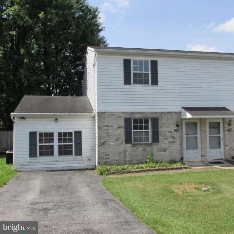 Build sweat equity in this 2 bedroom, 1 1/2 bath semi-detached home located close to major roadways and shopping. Private fenced back yard with deck. The one car garage has been converted into a family room with an ornamental fireplace for additional living space. First floor laundry and half bath. Property needs updating.