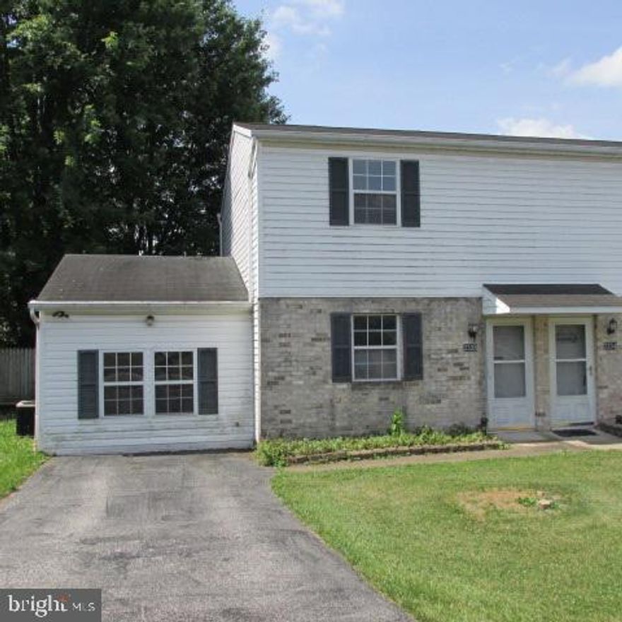 Build sweat equity in this 2 bedroom, 1 1/2 bath semi-detached home located close to major roadways and shopping. Private fenced back yard with deck. The one car garage has been converted into a family room with an ornamental fireplace for additional living space. First floor laundry and half bath. Property needs updating.