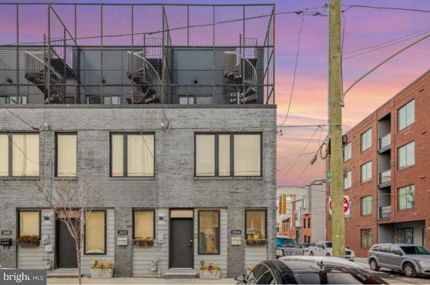 Welcome to 2614 Trenton Ave – a beautiful designer townhouse nestled in the vibrant heart of Fishtown!

Step inside and you’re greeted by a sun-drenched, open-concept living space, where gleaming hardwood floors and oversized windows create a warm, inviting atmosphere. The seamless flow into the dining area leads to a stylish kitchen outfitted with white shaker cabinetry, sleek quartz countertops, a classic subway tile backsplash, and stainless steel appliances. The breakfast bar offers the perfect perch for casual dining or entertaining.

Just beyond the kitchen, step out to a private rear patio — ideal for your morning coffee, evening unwind, or weekend grilling sessions.

On the second floor, you’ll find two bright and airy bedrooms, a spacious full bathroom, and a convenient laundry room with a full-sized washer and dryer.

The third floor is your personal retreat — a luxurious primary suite featuring a spa-inspired en-suite bathroom with double vanity and a soaking tub. Enjoy your own private balcony, or head up the stairs to the expansive roof deck with breathtaking 360-degree views of the Philadelphia skyline — a true showstopper.

Don’t miss your chance to live in one of Philly’s most desirable neighborhoods, with top dining, coffee shops, and nightlife just steps away.
