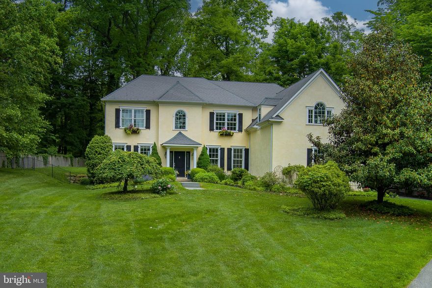 Set within an easily accessible neighborhood on a generous and manicured 1.2 acre parcel, this custom-built home, crafted in 2008, embodies the contemporary lifestyle and design preferences of its occupants. Boasting five bedrooms and four and a half baths, it offers abundant space for a growing family.
Approaching the entrance, you are greeted by a spacious two-story foyer, leading to a formal dining room on the right and a home office on the left. The dining room is perfect for hosting gatherings, flowing into a functional but stylish butler's pantry and a contemporary black and white kitchen equipped with   
high-end appliances and ample counter space. Natural light floods the informal dining area, which opens onto a bluestone terrace and pergola, extending the living space outdoors. The adjacent great room, warmed by a gas fireplace, is ideal for relaxation or entertaining, with a nearby office or study area for quiet concentration.
Upstairs, two family bedrooms share a bath and a third family bedroom is ensuite, while the primary bedroom boasts spacious closets and a luxurious bathroom. An additional finished space off the primary bedroom offers versatility, currently serving as an office but adaptable to various uses.
The lower level provides ample room for recreation and relaxation, featuring a large lounge area, a gym, and an additional bedroom and bath for guests' privacy.
Overall, this home offers a balance of modern design and practicality, providing a comfortable and inviting space for everyday living and entertaining.