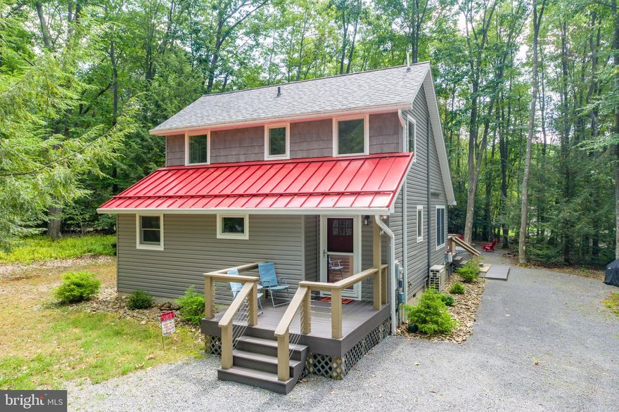 Charming Lake Access Cottage at Deep Creek Lake – Thoughtfully updated, this 3Bed 2Bath mountain lake getaway is located on the serene and private Skippers Estates Rd and offers beautiful community lake access with rotational dock slip available through HOA. The addition of the mini-split AC system provides year-round comfort, while the recently renovated pantry and flooring showcase a modern and stylish aesthetic. The heart of this cottage is the bright and cozy living space, with vaulted ceilings and plenty of glass to let in the abundance of natural light. The wood stove centerpiece invites you to gather inside during the cold winter months, or enjoy the outdoor deck, hot tub and firepit any time of the year. Home is being sold "turn-key", fully furnished. 48 Skipper Estates Rd is designed for relaxation and entertainment. Conveniently located just minutes from local restaurants, state parks and Wisp Resort… this humble abode offers the best of Deep Creek’s mountain lake lifestyle. Call today for details!