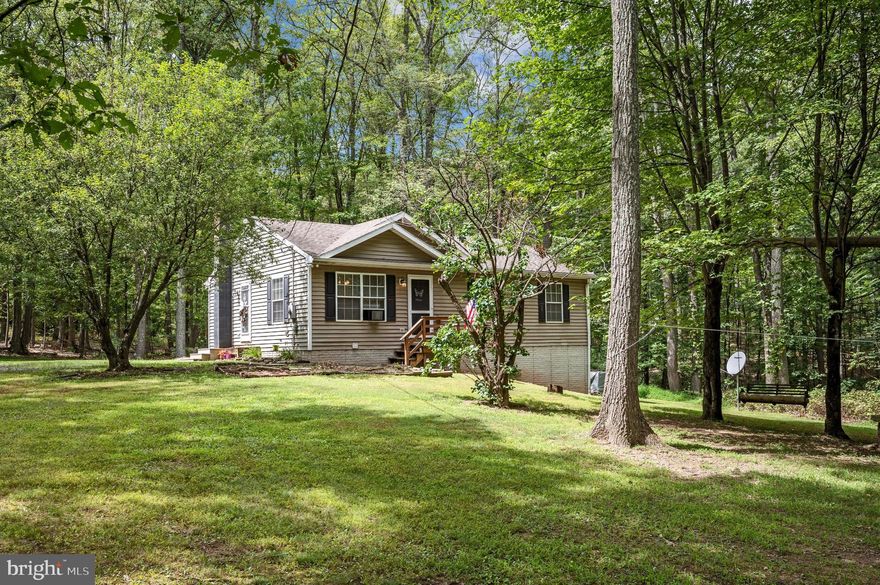 Looking to live in seclusion on 5 wooded acres? This charming 4-bedroom, 3-bath rancher is ready for its new owner! The home features 3 bedrooms and 2 full baths on the main level, with an additional bedroom and bath located in the finished walkout basement. The basement also includes a cozy wood stove and dry bar in the second living room, a finished bonus room, and a convenient laundry room. The open-concept main level boasts a spacious kitchen, dining, and living area—perfect for entertaining. Step out onto the peaceful back deck to enjoy serene views of West Virginia’s natural beauty with no neighbors in sight. Don’t miss out—this one won’t last long!