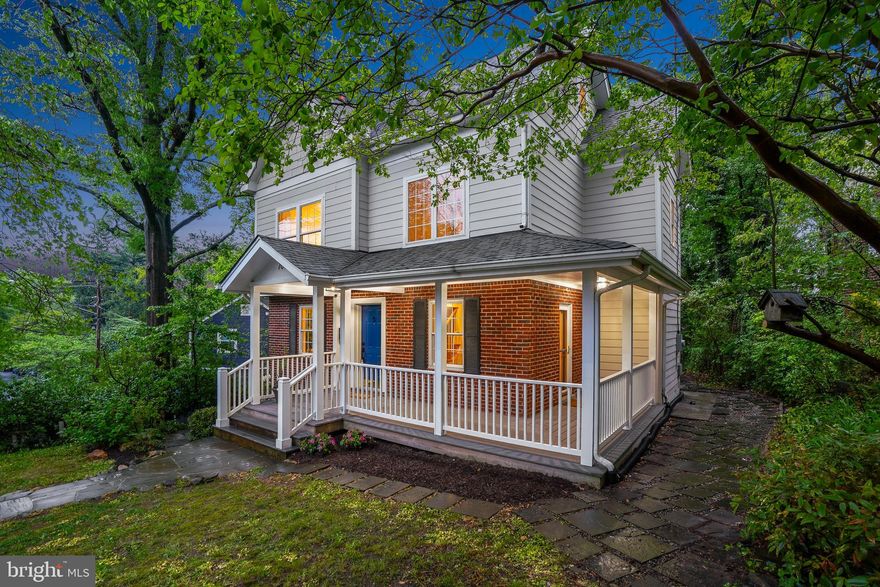 Welcome to 705 Elm Avenue, a spacious modern colonial with a charming covered wraparound front porch and a thoughtfully designed interior. The home offers a well-planned layout that balances architectural character with everyday comfort. Throughout, you’ll find hardwood floors, recessed lighting, an integrated speaker system, and detailed wood trim that add depth and style to the living spaces.
The gracious living room features a fireplace with mantel and connects to the breakfast room and kitchen through French doors. The expansive chef’s kitchen offers granite counters, handsome cabinetry, a large island with breakfast bar, and a GE Profile gas range with a built-in griddle. The breakfast room provides direct access to the rear composite deck. The kitchen also opens to the dining room with an elongated farmhouse chandelier, crown molding, and access to the wraparound front porch. This level is complete with a powder room and coat closet.

Upstairs, the second level provides four bedrooms with wood floors and two full baths. The primary bedroom suite is striking, featuring a two-story, gabled ceiling with a wall of windows, a wall of closets, and an impressive loft accessed by a spiral staircase. This versatile space can be used as an office or lounge and includes two window benches, a walk-in closet, a ceiling fan, and casement windows. The en-suite bathroom has updated fixtures and a new vanity counter. A linen closet is also located within the primary suite.

The lower level offers additional living space, featuring a sizeable family room with luxury vinyl flooring, recessed lighting, a built-in nook, and a wet bar. This level includes a full bathroom, under-stair storage, and a laundry room.

Outside, enjoy the inviting wraparound front porch, a low-maintenance composite rear deck, and a fenced backyard. Nestled in the lush South-of-Sligo neighborhood, just steps to parks, playgrounds, shops, restaurants, and transit. Enjoy living in eclectic Takoma Park—this location offers both charm and convenience, just minutes from the Red Line Metro station. Takoma Park has a warm sense of community and is also convenient to vibrant downtown Silver Spring.