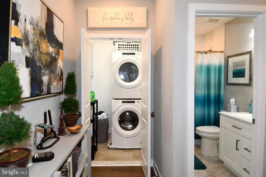 You won't want to miss this opportunity to own a beautiful recently restored end unit rowhome with a new roof and all updated systems in the Upton Gateway Neighborhood . With three thoughtfully designed floors above grade and a full unfinished basement currently set up as a separate level of office space , storage and two queen size bed spaces to allow for extra room for guests. You will enter the home into the light filled oversized living room with an adjacent dining space suitable for a large gathering of friends or family . The Kitchen is appointed with all new top of the line Frigidaire SS appliances an Island with Quartz Countertops and luxury cabinetry complete with 42 inch cabinets and ample space for everything you might need in the kitchen . A half bath compliments the first floor living area. Ascending to the second level you will find two good sized bedrooms with three windows each to allow ample light , one with an en-suite bath and walk-in closet and the other with a large closet space and hallway bath . There is also a dedicated Laundry Room and plenty of space in the hall . On to the top level of the home where you will find the primary suite with its own bath and walk-in closet along with a wall of windows for a light filled space . Adjacent to the primary you will find a sitting room area with access to the fantastic roof top deck area which completes the owners oasis on the top floor. The home has been fitted throughout with custom blinds on every window to ensure privacy when desired . Also outside the home you will have access to a small driveway area and both the public park next door and the dog park across the street . Walk to the Stadiums and the Historic Mount Vernon neighborhood . With everything this home has to offer and quick access to the city and major thoroughfares you will want to make this your first stop !