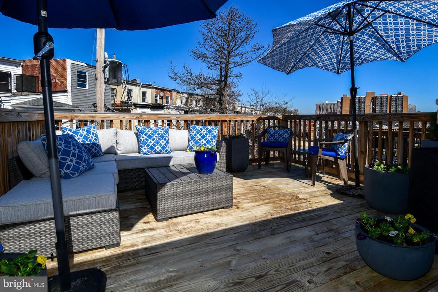 You won't want to miss this opportunity to own a beautiful recently restored end unit rowhome with a new roof and all updated systems in the Upton Gateway Neighborhood . With three thoughtfully designed floors above grade and a full unfinished basement currently set up as a separate level of office space , storage and two queen size bed spaces to allow for extra room for guests. You will enter the home into the light filled oversized living room with an adjacent dining space suitable for a large gathering of friends or family . The Kitchen is appointed with all new top of the line Frigidaire SS appliances an Island with Quartz Countertops and luxury cabinetry complete with 42 inch cabinets and ample space for everything you might need in the kitchen . A half bath compliments the first floor living area. Ascending to the second level you will find two good sized bedrooms with three windows each to allow ample light , one with an en-suite bath and walk-in closet and the other with a large closet space and hallway bath . There is also a dedicated Laundry Room and plenty of space in the hall . On to the top level of the home where you will find the primary suite with its own bath and walk-in closet along with a wall of windows for a light filled space . Adjacent to the primary you will find a sitting room area with access to the fantastic roof top deck area which completes the owners oasis on the top floor. The home has been fitted throughout with custom blinds on every window to ensure privacy when desired . Also outside the home you will have access to a small driveway area and both the public park next door and the dog park across the street . Walk to the Stadiums and the Historic Mount Vernon neighborhood . With everything this home has to offer and quick access to the city and major thoroughfares you will want to make this your first stop !