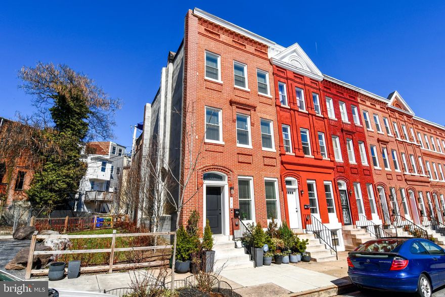 You won't want to miss this opportunity to own a beautiful recently restored end unit rowhome with a new roof and all updated systems in the Upton Gateway Neighborhood . With three thoughtfully designed floors above grade and a full unfinished basement currently set up as a separate level of office space , storage and two queen size bed spaces to allow for extra room for guests. You will enter the home into the light filled oversized living room with an adjacent dining space suitable for a large gathering of friends or family . The Kitchen is appointed with all new top of the line Frigidaire SS appliances an Island with Quartz Countertops and luxury cabinetry complete with 42 inch cabinets and ample space for everything you might need in the kitchen . A half bath compliments the first floor living area. Ascending to the second level you will find two good sized bedrooms with three windows each to allow ample light , one with an en-suite bath and walk-in closet and the other with a large closet space and hallway bath . There is also a dedicated Laundry Room and plenty of space in the hall . On to the top level of the home where you will find the primary suite with its own bath and walk-in closet along with a wall of windows for a light filled space . Adjacent to the primary you will find a sitting room area with access to the fantastic roof top deck area which completes the owners oasis on the top floor. The home has been fitted throughout with custom blinds on every window to ensure privacy when desired . Also outside the home you will have access to a small driveway area and both the public park next door and the dog park across the street . Walk to the Stadiums and the Historic Mount Vernon neighborhood . With everything this home has to offer and quick access to the city and major thoroughfares you will want to make this your first stop !