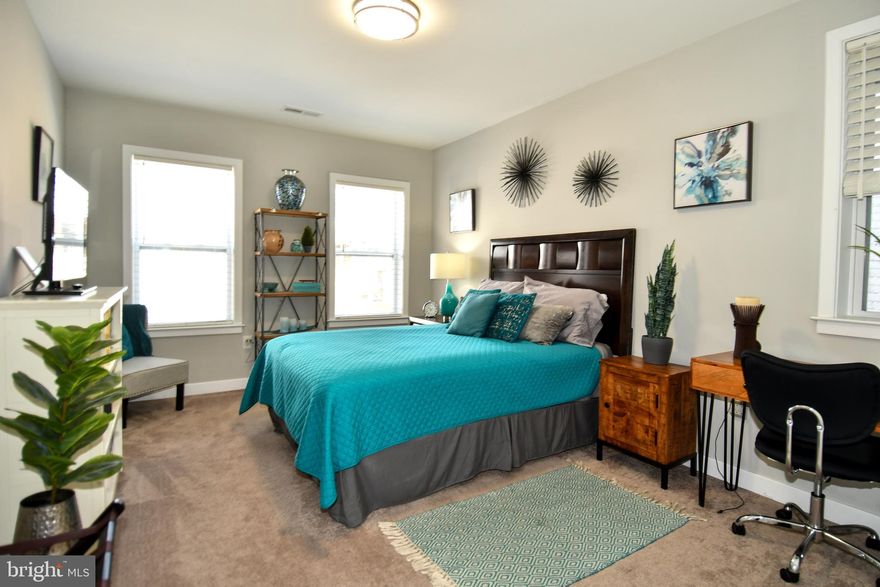 You won't want to miss this opportunity to own a beautiful recently restored end unit rowhome with a new roof and all updated systems in the Upton Gateway Neighborhood . With three thoughtfully designed floors above grade and a full unfinished basement currently set up as a separate level of office space , storage and two queen size bed spaces to allow for extra room for guests. You will enter the home into the light filled oversized living room with an adjacent dining space suitable for a large gathering of friends or family . The Kitchen is appointed with all new top of the line Frigidaire SS appliances an Island with Quartz Countertops and luxury cabinetry complete with 42 inch cabinets and ample space for everything you might need in the kitchen . A half bath compliments the first floor living area. Ascending to the second level you will find two good sized bedrooms with three windows each to allow ample light , one with an en-suite bath and walk-in closet and the other with a large closet space and hallway bath . There is also a dedicated Laundry Room and plenty of space in the hall . On to the top level of the home where you will find the primary suite with its own bath and walk-in closet along with a wall of windows for a light filled space . Adjacent to the primary you will find a sitting room area with access to the fantastic roof top deck area which completes the owners oasis on the top floor. The home has been fitted throughout with custom blinds on every window to ensure privacy when desired . Also outside the home you will have access to a small driveway area and both the public park next door and the dog park across the street . Walk to the Stadiums and the Historic Mount Vernon neighborhood . With everything this home has to offer and quick access to the city and major thoroughfares you will want to make this your first stop !