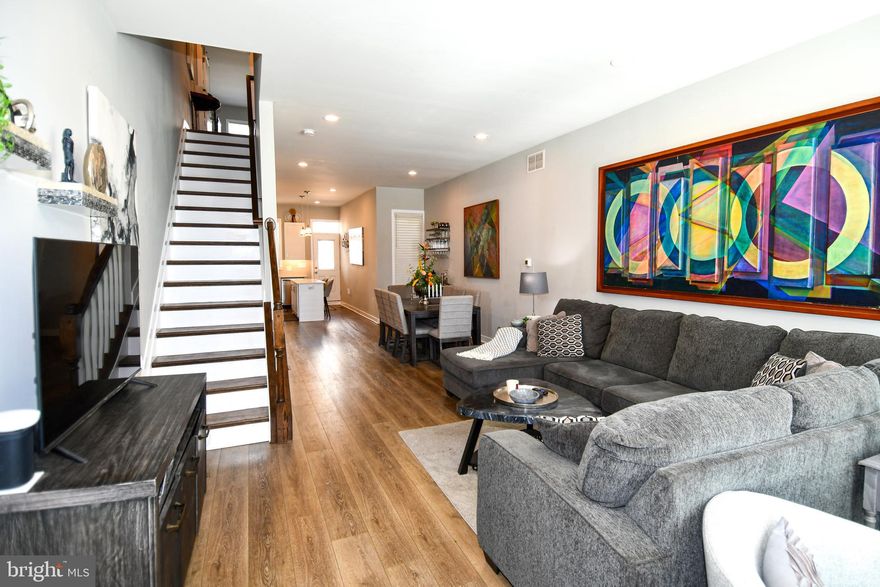 You won't want to miss this opportunity to own a beautiful recently restored end unit rowhome with a new roof and all updated systems in the Upton Gateway Neighborhood . With three thoughtfully designed floors above grade and a full unfinished basement currently set up as a separate level of office space , storage and two queen size bed spaces to allow for extra room for guests. You will enter the home into the light filled oversized living room with an adjacent dining space suitable for a large gathering of friends or family . The Kitchen is appointed with all new top of the line Frigidaire SS appliances an Island with Quartz Countertops and luxury cabinetry complete with 42 inch cabinets and ample space for everything you might need in the kitchen . A half bath compliments the first floor living area. Ascending to the second level you will find two good sized bedrooms with three windows each to allow ample light , one with an en-suite bath and walk-in closet and the other with a large closet space and hallway bath . There is also a dedicated Laundry Room and plenty of space in the hall . On to the top level of the home where you will find the primary suite with its own bath and walk-in closet along with a wall of windows for a light filled space . Adjacent to the primary you will find a sitting room area with access to the fantastic roof top deck area which completes the owners oasis on the top floor. The home has been fitted throughout with custom blinds on every window to ensure privacy when desired . Also outside the home you will have access to a small driveway area and both the public park next door and the dog park across the street . Walk to the Stadiums and the Historic Mount Vernon neighborhood . With everything this home has to offer and quick access to the city and major thoroughfares you will want to make this your first stop !