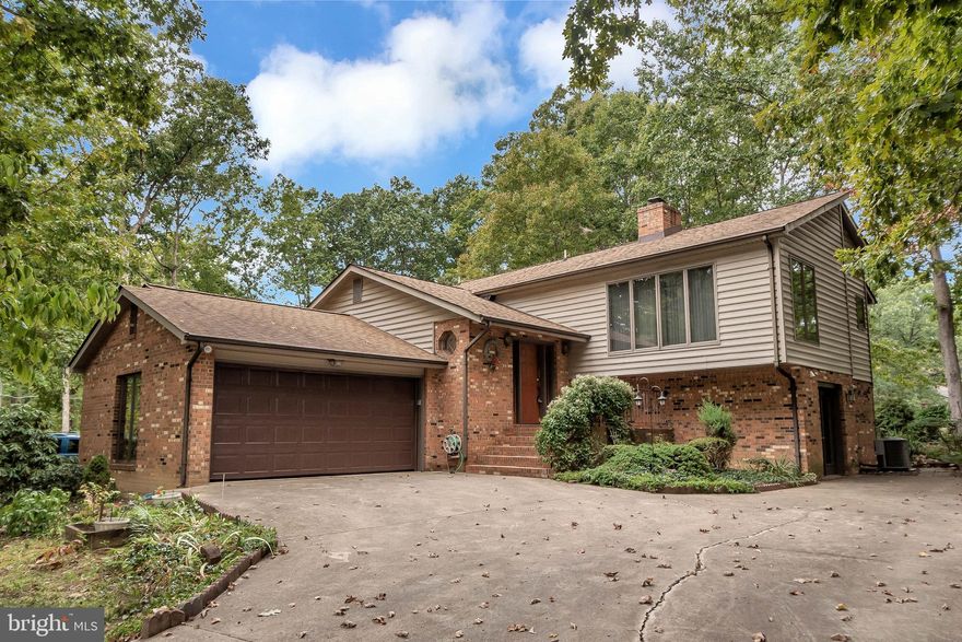 Entertain in grand style in this amazing home!  All wood floors on main level, with an entry level family room.  Cathedral ceilings in living room with an all brick gas fireplace.  The master bedroom has french doors leading to deck.  Enjoy a cup of coffee in the morning looking out to the golf course.  A private, gated, secured community, Lake of the Woods offers anything and everything you could possibly want. Home to two lakes (the 550 acre main lake and a 35 acre "fishing lake"), a golf course, an equestrian center, a fire and rescue department, and a church all within the gates, Lake of the Woods simply has it all. Whether your passion is boating, waterskiing, kayaking, golfing, horseback riding, or simply taking in the breathtaking views from the clubhouse while enjoying a fabulous meal, from your own deck or yard, or from one of the beaches, you won't be disappointed! Perhaps you'd like a game of bridge or volunteering your time and talents...Lake of the Woods offers more than 60 clubs and/or organizations from which you may choose to become involved. Located in Orange County, we are fortunate to enjoy low real estate taxes. Coupled with home prices ranging from the mid-$100,000 to over $2,000,000, Lake of the Woods is the perfect community for both full-time residents, as well as weekenders. But don't take my word for it, please come see for yourself! I will gladly give you a tour of Lake of the Woods by boat and by car so that you may experience why I love Lake of the Woods!