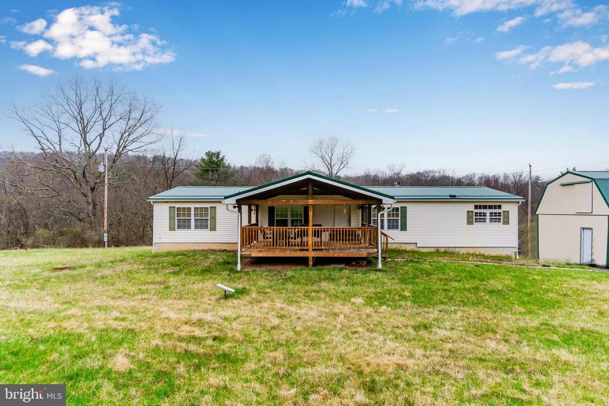 This 3-bedroom, 2-bath home sits on a level corner lot with just over 5 acres of mostly cleared land, surrounded by tree lines for added privacy. Enjoy peaceful countryside views from the covered front deck, a perfect spot to relax and take in the outdoors.

Inside you'll find a spacious layout, a cozy stacked stone fireplace in the living room, and a primary suite with its own bathroom and jetted tub. The property also includes a large detached garage that provides room for vehicles, hobbies, or even a workshop. The back yard has a partially fenced yard for pets, and plenty of room to spread out and make it your own.

If you're looking for quiet, space, and a bit of land—this one’s worth a look.
