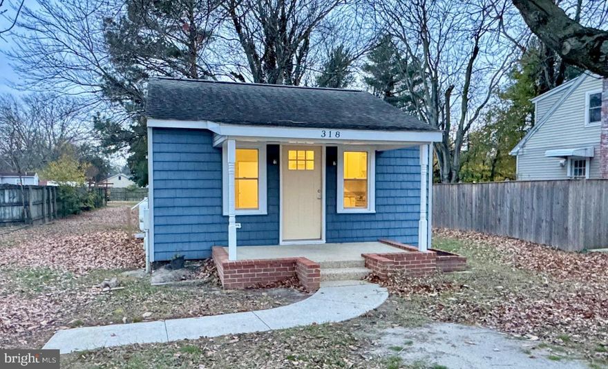 This charming bungalow, fully renovated in 2020 and move-in ready, blends modern comfort with timeless appeal. Behind the classic covered front porch, an open layout offers two bedrooms and two full bathrooms on a single level. The living and kitchen area features a vaulted ceiling with recessed lighting, enhancing the sense of space and adding a clean, modern feel to this efficient floor plan.
The living and dining areas flow seamlessly into the completely remodeled kitchen, which was reconfigured during the renovation and now includes new cabinetry, granite countertops, stainless steel appliances, a gas oven/range, built-in microwave, dishwasher, garbage disposal, and instant hot water. A stacking washer/dryer adds convenience to the home’s thoughtful layout.
The 2020 renovation was comprehensive, incorporating all new walls, ceilings, and doors, as well as new floor joists, subflooring, updated plumbing, spray-foam insulation, updated electrical, energy-efficient replacement windows and exterior doors, HVAC, and a tankless Rinnai water heater. The home features laminate flooring with cork backing, offering a warm underfoot feel, sound absorption, and easy maintenance.
The fully renovated and remodeled bathrooms feel fresh and contemporary. Each features modern fixtures, vanities, and coordinating lighting. The private primary bath offers a step-in shower with brushed-nickel hardware, while the guest bath includes a tub/shower combination accented by a stylish blue patterned tile surround.
Outside, the 0.19± acre lot offers a manageable yard with off-street parking and a generous 12' x 24' shed complete with windows, a garage-style door with ramp, and a side entry door—ideal for storage, hobbies, or a workshop. A propane tank services the home’s gas appliances, and the side entry to the house, located near the propane tank, provides convenient everyday access.
Located just minutes from shopping, dining, and everyday services in Denton, the home also offers quick access to Route 404—placing the Delaware beaches within an easy drive for weekend trips or seasonal getaways.
Thoughtfully updated and move-in ready, this tiny house with big improvements offers efficient living without compromising comfort or style. Some photos are virtually staged to add decor and furnishings for conceptual purposes.
