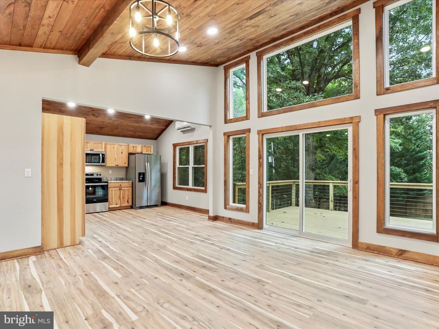 This stunning 5-bedroom, 4-bathroom home has been refined from top to bottom, inside and out and now offers over 2,500 square feet of stylish living space.   This home showcases exquisite craftsmanship with tongue and groove wood ceilings, solid wood interior doors and trim that gives this property a rustic yet current charm.  The modern eat-in kitchen boasts stainless appliances, granite countertops, and hickory wood cabinetry,  ideal for family gatherings. The master suite is a private oasis with a luxurious ensuite bathroom with beautiful tile shower and large double bowl vanity and a walk-in closet. There is also private access to the large deck for morning coffee with gorgeous views of Sleepy Creek Mountain.  Each additional bedroom is generously sized and bathrooms are completely renovated and offer all new fixtures with plenty of natural light.  Live stress free with confidence in knowing your HVAC, roofing, windows, exterior doors, plumbing and electrical fixtures are brandnew.  Outside, the 3.6 acres of beautiful hardwood trees surround the home and provides a relaxing serene retreat. This home is a must-see, offering comfort, style, and rustic appeal in a desirable neighborhood.  Agent is Seller