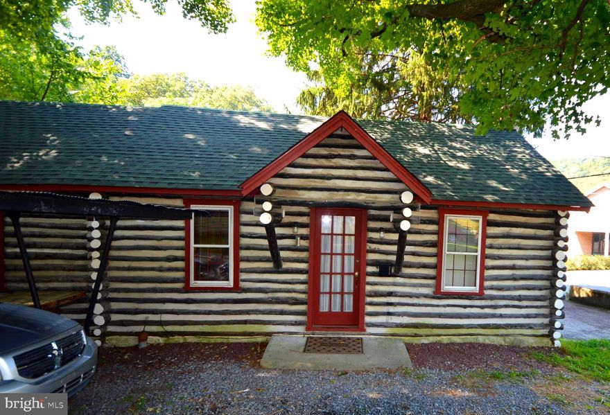 Cabin living walking distance from downtown Berkeley Springs. This adorable log cabin consists of a little dining area off the kitchen, living room, bathroom with claw foot tub, bedroom with walkin closet and another space that could be used as an office or even second bedroom. Enjoy your morning coffee on the adorable porch overlooking that stream bed that runs right underneath the house. This place is too adorable to be on the market long!