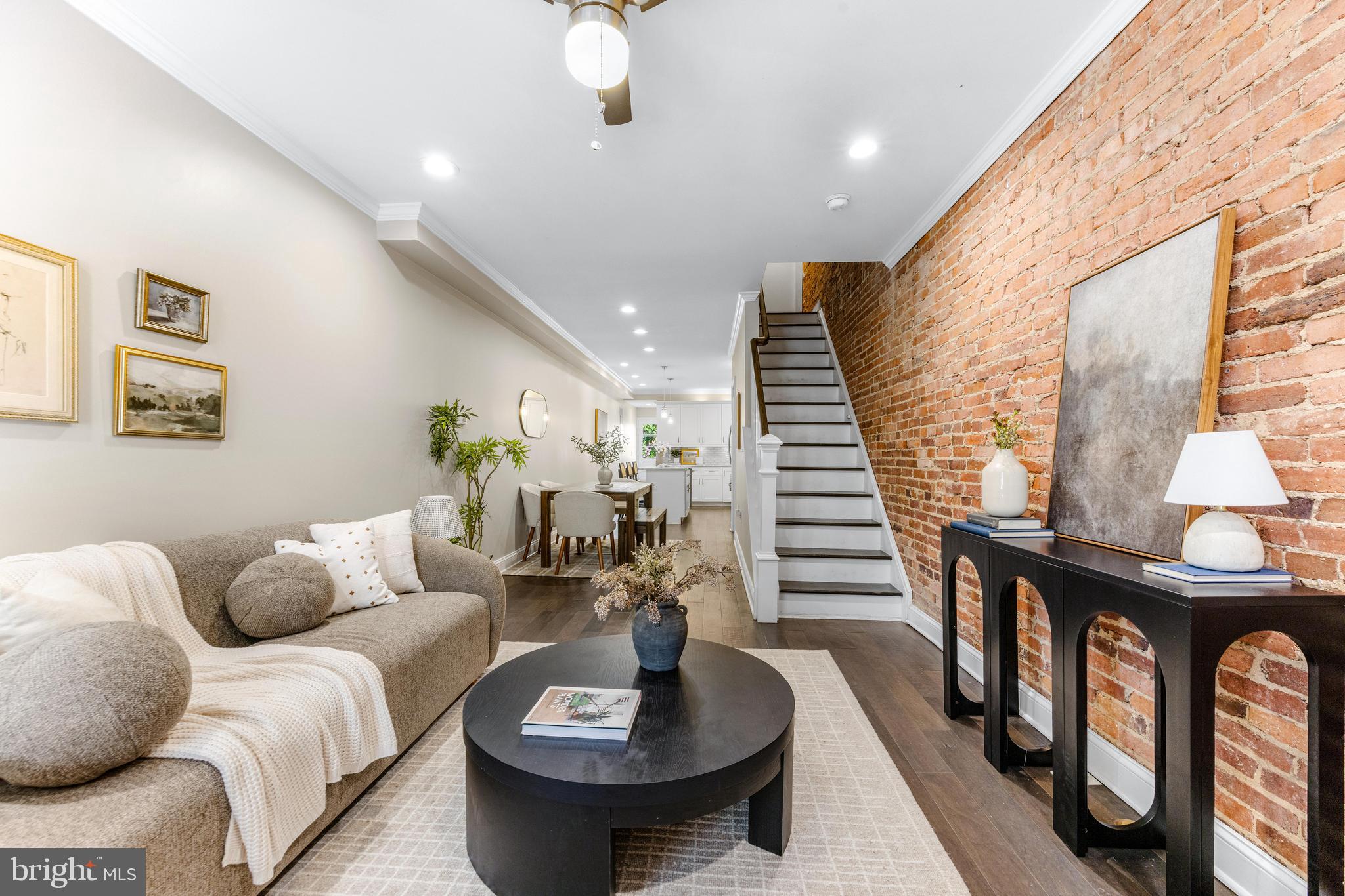 Say hello to 3104 Foster Ave, a classic Baltimore row home offering 2 off street parking spots with an A+ location where you can head straight out your door down to Canton Waterfront or up to Patterson Park. This property was fully renovated with CHAP tax credit approval in 2019 - providing roughly 5 years left of insane tax savings. For reference, after the CHAP tax credit is applied for 2025, the tax bill is around $4,957.60 basically 50% less than standard tax bill. MASSIVE SAVINGS. Inside you will immediately notice the classic exposed brick on main level, hardwood floors across main & upper level and a fresh coat of paint. The kitchen is the main event in this house - with a large island with sink & dishwasher, abundance of beautiful white cabinetry, stainless steel appliances, light grey and white granite countertops and gorgeous grey tile backsplash. Continuing past kitchen is a convenient main level 1/2 bathroom and exterior door leading out to an actual fenced in "backyard" / patio and behind the fence, you'll find not 1 parking spot but 2 actual parking spots - this is a rare find in Baltimore City! Upstairs offers 2 bedrooms + 2 full bathrooms, downstairs offer 2 more bedrooms + 1 full bathroom. The upper level hallways has a laundry closet with side by side washer / dryer and hallway door leads to exterior steps to a must have Baltimore City rooftop deck with city skyline views. Come enjoy the fall season in your new home on Foster!