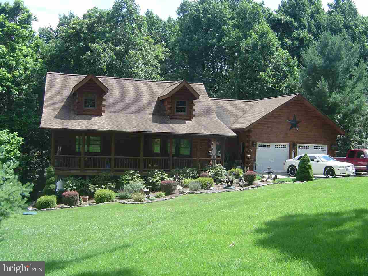 It feels like home as soon as you walk thru the front door! Beautiful details throughout this modern log home, incl. exposed wood beams, loft, vaulted ceilings, wood floors & white pine walls. Gourmet kit. w/black granite counters, island & tile floor. French doors lead onto a huge deck that spans the entire width of the house. Covered front porch. Large master suite w/step-in closets, full BA & jetted tub. Full w/o basement w/granite top bar.
