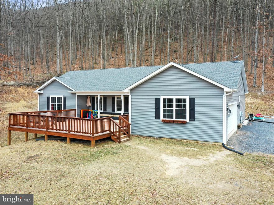 Welcome to your dream home—where modern design meets natural serenity. Bult in 2022, this beautifully crafted contemporary 3 bedroom residence is nestled on over 4.5+ acres of private land, offering peace, privacy, and panoramic views that will take your breath away. Step inside to an open-concept floor plan filled with natural light, high ceilings, and upscale finishes throughout. The gourmet kitchen features granite countertops, stainless steel appliances, and a spacious island perfect for entertaining. The living area flows seamlessly onto a large front deck that overlooks the surrounding landscape—ideal for morning coffee, sunset dinners, or simply soaking in the view! The unfinished basement is great for additional living and entertainment space, framed and ready to make additional rooms and roughed in and ready for another bath to be added.