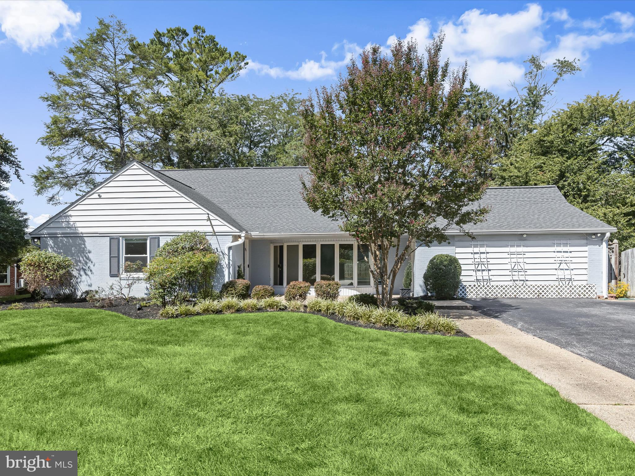 Tucked on one of the most sought-after lots in Long Meadow Estates, this as-is mid-century modern inspired four-bedroom, three-bathroom home offers over 3,200 square feet of finished living space and a truly remarkable backyard retreat.
Mature landscaping and a tree-lined rear yard frame this home, while an oversized driveway provides ample parking. Step inside to a welcoming foyer that opens into an expansive living and dining area, complete with gleaming hardwood floors, an oversized bay window, a wood-burning fireplace, recessed lighting, and custom display shelving. Sliding doors lead directly to the resort-style backyard for seamless indoor-outdoor entertaining.
At the heart of the home, designed with a nod to mid-century modern aesthetics, the renovated kitchen offers both style and substance. Granite countertops and sleek tile flooring set the stage for upgraded appliances, including a five-burner gas cooktop with a stainless steel hood, double wall ovens, and a GE Monogram stainless steel refrigerator. An adjacent breakfast nook, planning desk, upgraded tile flooring, and a mix of recessed and chandelier lighting add warmth and practicality. Just off the kitchen, the inviting family room features a mid-century modern built-in, recessed lighting, faux wood blinds, and convenient access to the front yard, offering yet another space to relax or entertain.
Tucked away from the main living areas, the owner's suite offers a quiet retreat with its own formal dressing area. The spa-inspired en-suite bathroom features a freestanding soaking tub, double vanity, designer tile shower with dual shower heads, stylish lighting, and elegant finishes. Warm wood flooring adds a touch of refinement, completing this thoughtfully designed space. A second bedroom, full hallway bath, and a laundry room with front-loading washer and dryer, utility sink, and storage cabinets complete the main level. The upper level offers two comfortably sized bedrooms, a modernized hall bath, and the bonus of an oversized walk-in storage closet.
The true standout of this home is the private backyard escape, fully fenced and designed for relaxation, with a freshwater pool, a wood sun deck, a stamped concrete patio beneath the covered patio. Modern conveniences and recent updates include a smart security setup with video and doorbell cameras, an in-ground irrigation system to keep the landscaping lush, and a recently installed water heater. A newer architectural shingle roof adds peace of mind, while abundant storage throughout the home offers everyday practicality.
Ideally located near the Falls Road corridor, The Quarry Shops, and major commuter routes including I-695 and I-83, this distinctive as-is available home offers style, comfort and convenience.
Note: Select interior photos have been virtually staged.