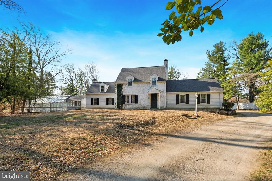 This is the one you've been waiting for!  Nestled on 1.5 acres, this Extraordinary 3-bedroom, 2.5-bath single-family home blends timeless elegance with modern comfort and a gardeners delight. Upon entry, you’re greeted by a beautiful flagstone foyer and an elegant front staircase that sets the tone for the home’s classic design. Decorative arched doorways, crown molding, chair rail, solid wood doors and sconce accents add to the refined character throughout the home. The expansive 25x19 Great Room is a true highlight, featuring vaulted ceilings with exposed wood beams, oversized decorative pendant lighting, and a striking floor to ceiling stone gas fireplace with a slate hearth. A charming split barn door and ceiling fan complement the space, while a French double-door exit leads to the rear slate patio—perfect for entertaining or relaxing. The formal dining room, accessed through a split pocket door, is bathed in natural light and boasts two built-in corner cupboards, a separate built-in cabinet, crown molding, chair rail, and beautiful pegged hardwood flooring. The room’s elegant ambiance makes it ideal for family dinners or hosting guests and is conveniently located right off the kitchen. The kitchen is designed for functionality with wood cabinetry, a stainless-steel sink and countertops, a ceramic tile windowsill, and ample cabinetry for all your storage needs, with the ceramic tile flooring adding a touch of charm. Step into the Bonus Room, once the parlor where important news was once heard on the radio, offering many possibilities for use—be it a quiet reading room, home office, breakfast, or playroom. The home features solid hardwood floors, high baseboards, and wall sconces throughout, maintaining a consistent level of quality and sophistication. A front and back staircase provide easy access to the upper level, where all the bedrooms are generously sized and equipped with ample closet space. One bedroom offers its own private powder room, once home to a small tub. The gorgeous upstairs landing provides character including two large closets and access to pull-down attic steps for added storage. The unfinished basement includes plentiful shelving, storage closets, and a crawl space under the family room. A 2-car garage ensures convenience and ample space for storage, vehicles or outdoor equipment. Off the garage, enjoy a beautiful sunroom with vaulted ceilings and a wood-burning fireplace—ideal for year-round relaxation. The sunroom leads to another powder room and a charming greenhouse, adding extra appeal to the home’s functional layout. This property also offers an inground gunite Sullivan pool, perfect for summer enjoyment. With many updates and newer features throughout, this home combines classic charm with modern amenities. Don’t miss the opportunity to own this extraordinary property.  Let's talk about location!  This home is conveniently located in Colonial school district, close to all major arteries allowing you to get to Philadelphia International Airport, Center City Philadelphia, the PA Turnpike, Northeast Extension and so many Shops and Restaurants you will not be disappointed with the ease of commuting from this home!