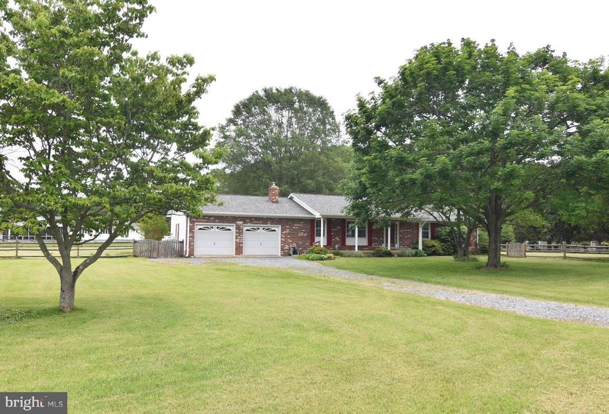 Well cared for rambler on beautiful lot.  Open floor plan, hardwood floors, updated kitchen with granite, gas stove, breakfast bar.  Brick fireplace with wood stove.  HVAC replaced 2018, propane back up,  Roof aprox 2 years old, Well was replaced 2012.  Water filter system.  Insulated garage with extra electric panel. Fenced side & back yard with 2 gates.  Awesome level lot with plenty of space for garden, dogs, playground, etc..... Walking distance to neighbor pier.  House has been freshly painted.  Shows well. Offers will be presented Monday June 1 at 9 am.