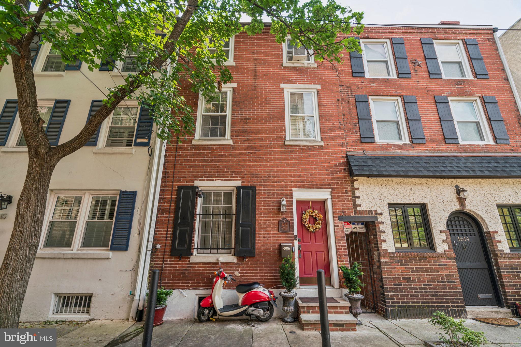 Storybook 2 bedroom home in the Greenfield school catchment with delightful, easily accessed fenced yard (for your doggie) on beautiful Addison St in Rittenhouse. Also near Avenue of the Arts/Broad St. Quiet, tree-lined block. Handsome brick front single family home where you have control (no condo rules). Feel the warmth of home sweet home when you enter into the living room + dining area with a door to the yard. From the yard, there is alley access to the street for your trash cans and bike. Notice the hardwood floors, generous ceiling height and smart kitchen with exposed brick near the living room. Outdoors is a true oasis. Grill, garden, entertain, relax. Up the turned stairs to the first bedroom, currently used as a combination guest room/office. Decorative fireplace mantel. Full tiled bathroom on this floor has a tub and shower. The top floor is a spacious primary bedroom with terrific light, vaulted ceiling and storage. Charming. Basement for storage and laundry. Convenient to Penn, Jefferson, CHOP, the commercial district, transit, fabulous restaurants, boutiques and all that Center City Philadelphia has to offer. Schedule your showing today!