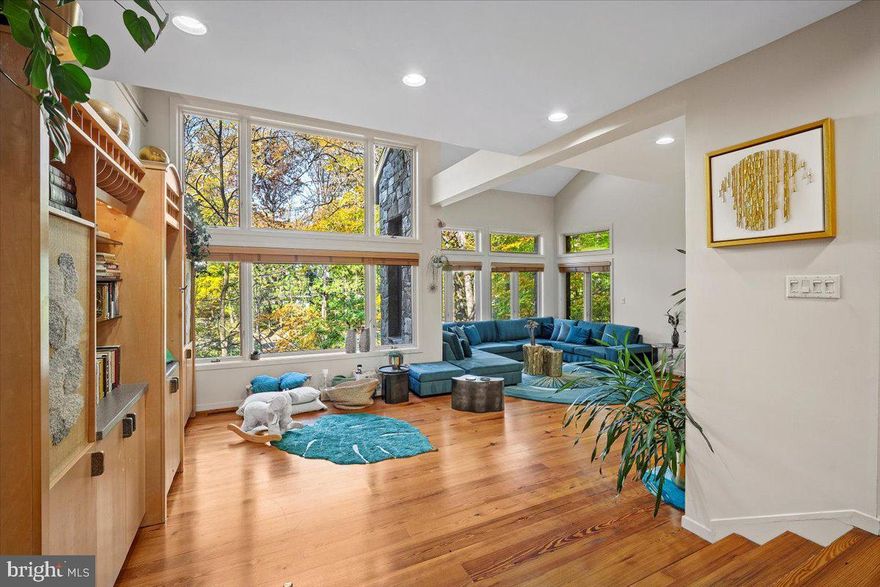 IMPROVED PRICE FOR THIS STUNNING CONTEMPORARY HOME!   
Welcome to 6707 Broxburn Drive, a stunning contemporary residence that exudes modern sophistication, luxury, and smart design, nestled on an idyllic, treed 1.06-acre lot in the close-in Bannockburn neighborhood of Bethesda. This architectural gem, built in 1985 by the renowned local developer Clarence Kettler, offers over 6,700 finished square feet (est) of luxurious living space across 3 levels. 

Outside, the property offers serenity, privacy and gorgeous natural treed views.  The stunning stone facade, the flagstone walkways, the stacked stone retaining walls, and the wrap-around decking across the back and side of the home will have you feeling as though Aspen has been relocated to Bethesda.  You and your visitors will delight over the most charming entry walkway bridge over a sweet, babbling brook and the large flat backyard. 

Step inside to discover expansive spaces, perfect for hosting multi-generational families or your entire friend squad. The home features five exceptionally large bedrooms and four and a half updated bathrooms. The home's design makes it feel like an immense tree house, with huge windows offering stunning views from every angle. The sunken living room features a double height vaulted ceiling, a double-sided stone fireplace, and gorgeous wide-plank pine floors.  The spacious dining area can accommodate your larger gatherings.  A large den/family room features another fireplace, built-ins and French doors, making it a perfectly cozy retreat to enjoy a movie or a book.  The extra large kitchen features a huge island with custom concrete counters, tons of storage, commercial grade stove, high-end stainless steel appliances, a gas fireplace, and a large adjoining sunroom/breakfast room.  With several doors  leading to the outside deck and yard, this home is perfect for indoor/outdoor entertaining. 

On the upper level, there is a large open space bonus room, perfect for a playroom or secondary living space.  Tired of the typical small bedrooms with no closet space?  All the bedrooms in the home are extra large, some with bonus play rooms/dens attached, and have great closet space in each.  On the entry level, you'll find the 5th bedroom (also huge), the 4th full bath, a bonus home office/flex room with French doors to the outside, another den, access to the 2-car garage with an EV charger, and excellent storage/utility/workshop spaces. 

At the heart of the home is the dramatic open staircase with eye-catching views at every step. Recent updates include a high-quality architectural shingle roof (new in 2021) and replaced skylights with automatic shades (also replaced in 2021), and a whole-house water filtration system.  

If this idyllic home were not enough, the location will surely close the deal.  Located in the Bannockburn/Pyle/Whitman public school districts and only about 10 minutes to downtown Bethesda or to the DC line, every amenity is close by, as well as quick access to major commuter routes including the Beltway, Clara Barton Parkway, and Cabin John Parkway.

This home is not just a place to live, but a lifestyle to embrace. Don't miss the opportunity to make this extraordinary property your own.