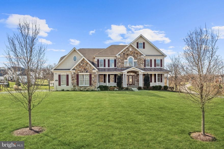 Built by Toll Brothers, this luxury estate home in Cattail Overlook, is thoughtfully designed with quality and lifestyle options in mind. Enjoy strong moldings, classical columns, gleaming hardwood floors, lofty windows, and skylights that stream light into this spacious open floor plan.

A grand two-story foyer and dramatic dual staircase with sweeping curves unfolds to welcome guests like a pair of open arms and is flanked by living and dining formals. The beautiful, curved staircases provide seamless passage whilst framing views of the soaring stone fireplace on a central axis that will draw you into an impressive two-story great room crowned with deep coffered ceilings.

Adjacent to the great room, is a breakfast area and planning station that transitions into a large eat-in gourmet kitchen that surrounds a commanding contrast island and breakfast bar at center stage. Appointed with sleek stainless-steel appliances, gorgeous stone countertops, range hood, wall ovens, and a decorative backsplash that opens to a pass-through window, offering views of the light-filled sunroom with vaulted ceilings and skylights.

Designed for gatherings large and small, the open floor plan design also supports daily living and work at home options. At the heart and hub of the home, the expansive kitchen offers a walk-in pantry, nearby laundry, and mud room on one side, and easy access to a wrap-around composite dining deck on the other side. The back hall leads to French doors that provide privacy for at-home work in the study, and the convenience of an adjacent powder room to service the main level.

Upstairs, the primary suite entry also offers French doors that open into a light and airy sitting room. A pair of classical columns announce entry into the bedroom suite with an elegant tray ceiling and spacious walk-in closet. Classical architectural language and French doors are repeated at the entry to a spectacular spa-like bath outfitted with a jetted tub, two oversized separate vanities, two separate toilet rooms, and a roomy walk-in shower with designer tile and a frameless glass enclosure. Not to be missed is the quintessential Toll Brothers walk-in closet over the garage that will accommodate the most extensive wardrobes and shoe collection imaginable! 
A generous hall linen closet, secondary back stair, and three additional bedrooms outfitted with three en-suite full baths encircle the upper landing that overlooks the great room and complete the upper-level sleeping quarters. 

The tasteful exterior front is finished with stone and features landscaped grounds, a wrap-around covered slate front porch with a barrel-vaulted ceiling over the front door and coupled columns to mark the entry. In the rear, a low-maintenance composite deck and stair with a vinyl clad rail system cascade down to a lush rear lawn and lower walk-out door to the unfinished lower level. Create your own lower-level recreation space with a cozy fireplace sided by full daylight windows standing at the  ready for your own dream lifestyle. Come home to luxury for daily living and gathering at Cattail Overlook.  IMMACULATE!