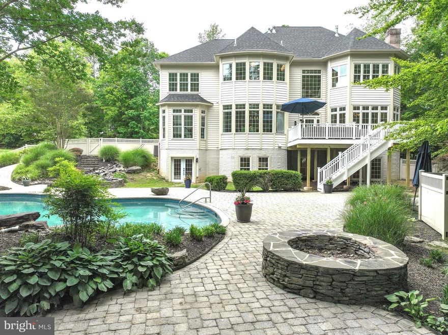 Welcome to your dream oasis in the heart of prestigious South River Colony, a Golf Course Community. This meticulously renovated luxury home offers an unparalleled lifestyle, combining modern elegance with tranquil outdoor living. With five spacious bedrooms and four full bathrooms plus a half bath, this residence is designed for both comfort and sophistication.

Step into the grand entrance featuring a new front door that opens to a world of exquisite details and finishes. Natural light pours in through all new Pella Custom Windows, illuminating the stunning hardwood floors and custom paint that flows seamlessly throughout the home. A large formal dining room is located to the right of the hallway – large enough to host your family and friends.  A formal living room overlooks the front yard and could be converted to a music room or study if desired.  Gather in the chef’s kitchen, which has been completely transformed with stainless steel appliances, a new 5 burner gas cooktop with pop-up vent and built-in microwave, elegant quartz countertops, updated brushed gold hardware, updated lighting --perfect for culinary enthusiasts and social gatherings alike. Adjacent to the kitchen is an office/library that boasts built-in bookshelves.  A mudroom is conveniently located off the 3-car side-load garage and has a built-in “drop zone” for your coats and backpacks.  To the left of the kitchen sits a large, two-story family room with a marble-surround gas fireplace, gleaming hardwood floors and a large, brushed gold chandelier as the room’s focal point.  The expansive living areas create an inviting space for family and friends.  As you walk through the double doors between the family room and kitchen, you will step onto a new, 20’x20’ maintenance-free deck that invites you to bask in the sun or host delightful gatherings under the stars.

On the second level, retreat to the opulent Primary Bedroom, a private sanctuary highlighted by a cozy gas fireplace—ideal for creating a warm ambiance during chilly evenings. The Primary Bathroom has been completely updated and features two large vanities with marble countertops and plenty of storage, new hardware, a custom tiled shower with niche and a free-standing bathtub to relax in after your busy days. Two large walk-in closets complete the Primary Bedroom Suite. Three additional large bedrooms and two full bathrooms (one is a Jack-and-Jill bathroom) are located on the second floor of this beautiful home. A BONUS AREA is located at the top of the second staircase and features built-in study zones, a window seat overlooking the pool and built-in bookcases.  The upstairs laundry area is located behind the double doors for convenience and functionality. 

The finished WALK-OUT BASEMENT is a true highlight, featuring a fifth bedroom and a full bathroom and a huge open recreation area that you can design the way you wish.  The unfinished storage room could also be finished if you require more space.  Step outside into your very own backyard paradise. Relax by the private inground swimming pool or unwind by the firepit as you enjoy the serene ambiance of the waterfall and pond features.  This home offers ample parking with a three-car side load garage, complete with new garage doors, ensuring convenience and luxury at every turn.  

Living in South River Colony means enjoying a wealth of amenities at your fingertips. Take advantage of two shimmering swimming pools, pickleball/tennis courts, basketball courts, and a delightful tot lot/playground for the little ones. Jogging paths wind through the community, leading to picturesque picnic areas, making it easy to embrace an active lifestyle. Golf enthusiasts will appreciate the option for golf course memberships, elevating your leisure activities to new heights.  New roof installed in 2024.  BLUE RIBBON SOUTH RIVER SCHOOL DISTRICT and conveniently located to all major commuting routes to Washington, DC, Annapolis or Baltimore.