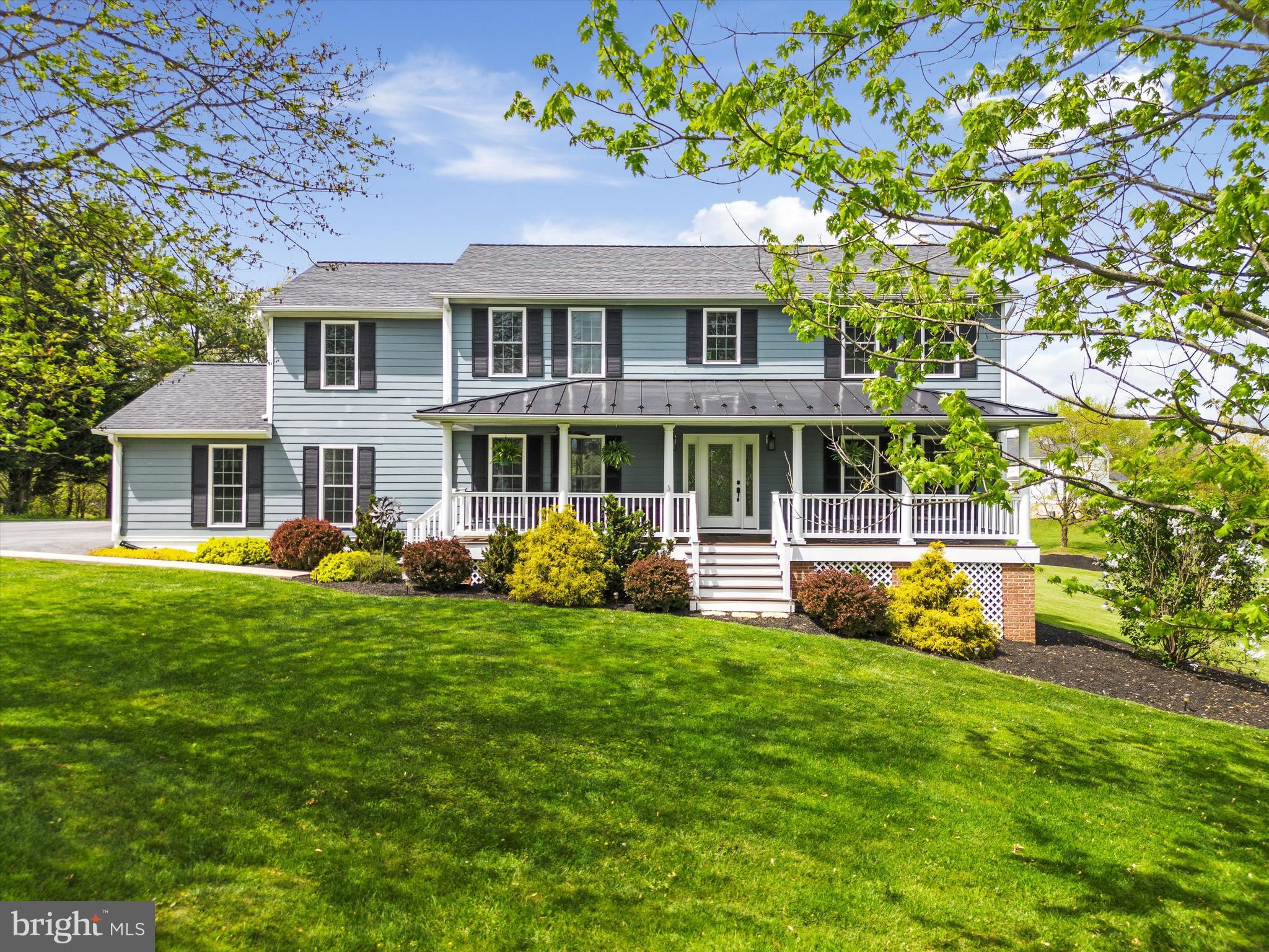 Spacious colonial built with attention to detail and convenience, situated on 2.1 acres of beautiful, lush terrain. The experience of this home starts on the broad traditional front porch with immaculate Trex decking and Hardiboard siding for longevity and fire resistance. The custom-made reclaimed antique wood accents, floors, and beams that open up the main level's two living areas with texture and depth are what first catch the eye. The eat-in kitchen with stainless-steel appliances and a gorgeous breakfast bar/island combo with extra seating is open to the expansive L-shaped living area with a comfortable Jotel propane fireplace to take the chill off and delight your eye. This area also leads to the expansive rear deck and then down to the firepit lounge area– both crisp and ready for grilling and entertaining. Through the kitchen, the butler’s pantry and mud room provides floor-to-ceiling storage with elegance. This is also the entry room from the 2-car attached side entry garage area. Upstairs are four spacious bedrooms, but the primary suite is really special! The bedroom is beautiful, which goes without saying, but the pair of huge closets, both with natural light, the adjoining bonus room (currently used as a gym), and the enormous en suite bathroom make an extraordinary sanctuary. The laundry room is located on the bedroom level for convenience. The full unfinished basement with walk out is ready for your customizations. Outside the scenic vista is private and beautiful, leading the eye to a small stream at the far end. Come see beauty, luxury and quality in harmony.