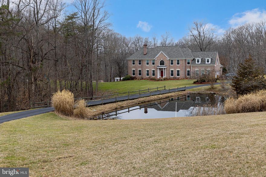 ** NOTE - UNDER AGENT REMARKS THAT AN OFFER DEADLINE OF 2/21 AT 10am HAS BEEN SET *** Your dream home awaits you with this stunning 5+ acre estate.  Seldom do you find a home with such an impressive entertainer’s dream exterior & an equally luxurious interior. This 20-room home also has 5 bathrooms & over 8000 total square feet. The idyllic water-access-location is securely nestled at the end of a quiet cul-de-sac & abuts Sandy Run Park—the DMV’s premier crewing facility.  View the water glistening through lush trees from your interior or your 4000+ ft. of deck & patio. Better yet, take a short stroll down the wooded path to kayak, fish or simply sit on the benches & enjoy the tranquil Occoquan Reservoir & one of Fairfax County's largest, most pristine & serene parks.  This one-of-a kind location allows you to live within 3 min. of the #123 yet (and less than 30 minutes to DC via the HOV), but in a secluded tranquil paradise away from the DMV stress in your own nature preserve with abundant flora and fauna!  This extraordinary property includes a large gunite pool, waterfall, screened-in pool house, 2 pergolas, built-in barbecue area, playground equipment, playhouse & more. This entertaining backyard can easily host your 50+ guest parties.  If you love gardening and fresh veggies, a barn/shed & plenty of easily maintained terraced beds await you—no green thumb necessary.  Horse lovers can easily transition this property & enjoy this acreage & nearby trails too.  This home also boasts a stocked pond & dozens of organically grown mature berry bushes, as well as a variety of fruit trees.  Spring greets you with hundreds of crocuses, daffodils & fragrant lavender.  This fully-renovated home will offer you not only a distinguished estate to call your own, but years of no hassle low-maintenance ownership.  Premium roof / High-efficiency HVAC system / Water systems / Windows / Water heater / Hardwood floors / Thermador kitchen appliances etc. are just a few of the many new & updated finishes & systems this fabulous home offers – many with extended warranties!  Stepping into this home you are greeted with a stunning curved staircase & marble entrance.  An office with beautiful built-ins & a formal living room immediately attest to the enduring quality of this well-appointed home.  The large dining room & spectacular sunroom allow you to enjoy the impressive views of your 5-acre estate.  The kitchen though, is where the high-end appliances & custom cabinetry really showcase why this home is so special!  Everything is built-in with paneled appliances & imported Taj Mahal counters, along with the adjoining laundry room/pantry which is also full of specialized cabinetry. This home also has the convenience of dual staircases & a spacious 3-car garage.  Off the lovely kitchen is a large family room which is flooded with light & enjoys a vaulted ceiling.  Upstairs you will find 4 large bedrooms, 3 updated bathrooms, walk-in closets & an opulent master suite. The large master bathroom along with a spacious closet full of custom built-ins and imported granite, an adjoining sitting room/retreat and stunning views complete this special space.  Downstairs the basement with imported stone flooring affords yet another office, a full exercise room, a recreation room, a game area, a media room, closets & storage galore along with another full bathroom & a 2nd kitchen & eating area for an au-pair or long-term guests!  This one-of-a-kind home must simply be viewed to appreciate! Enjoy life in Fairfax Station with its amazing convenient commute options, fabulous schools & world-class parks, water & trails.  Welcome home!