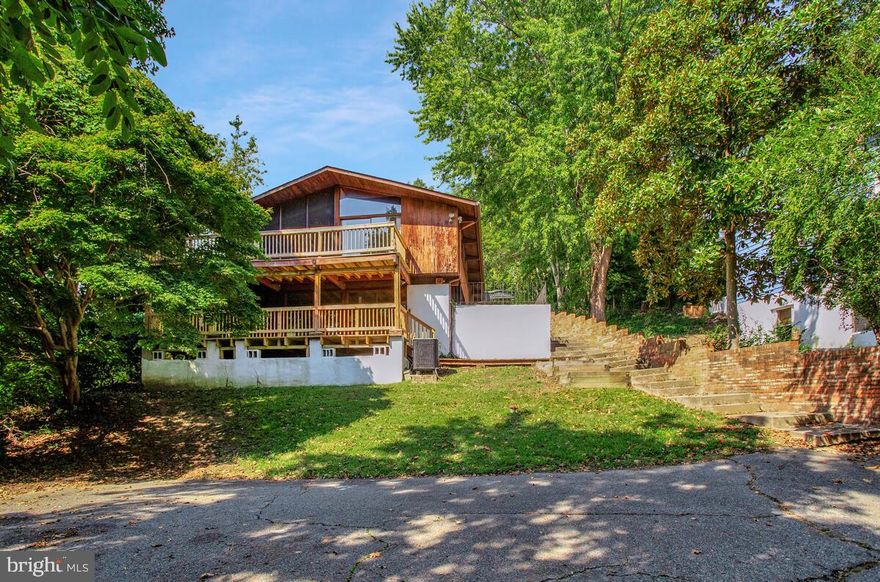 This is no cookie-cutter home! Welcome to 8205 F Street — a rare Acorn Deck House in Chesapeake Beach, designed to celebrate light, warmth, and natural materials. Known for their signature post-and-beam construction, soaring ceilings, and walls of glass, Acorn Deck Houses are architectural icons that blur the line between indoors and out — and this one delivers that feeling in full.

Expansive, beautiful windows connect every room to the outdoors and flood the home with natural brightness. Inside, you’ll find 3 bedrooms and 3 full baths anchored by two wood-burning fireplaces that bring character and cozy ambiance. Notable improvements include a new 50-year roof (2021), the replacement of both heat pumps (2025), and the resurfacing of both upper and lower decks (2025).

The open design creates flow, warmth, and connection — hallmarks of Acorn’s mid-century modern legacy. Step outside, and multiple decks extend that architectural vision to the trees and sky, while two driveways provide ample parking — perfect for hosting and entertaining.

If you’re seeking distinctive style and Chesapeake Beach charm, 8205 F Street is a true Deck House gem — equal parts art and architecture.